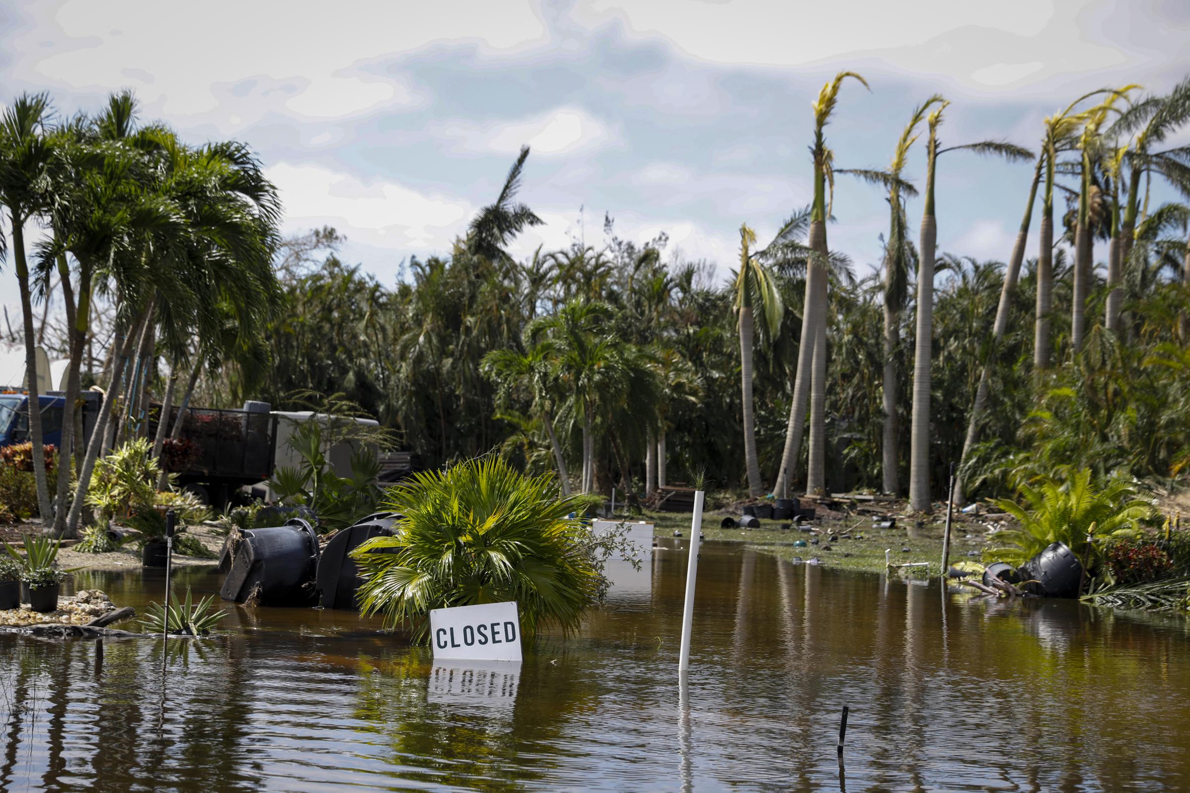 2022 - Hurricane Ian - A sign reads close in a flooded area following Hurricane...