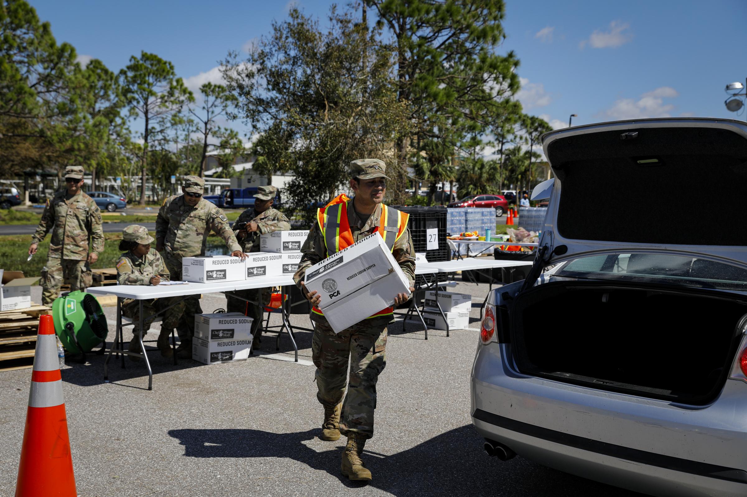 2022 - Hurricane Ian - Soldiers from U.S. Army distribute food following...
