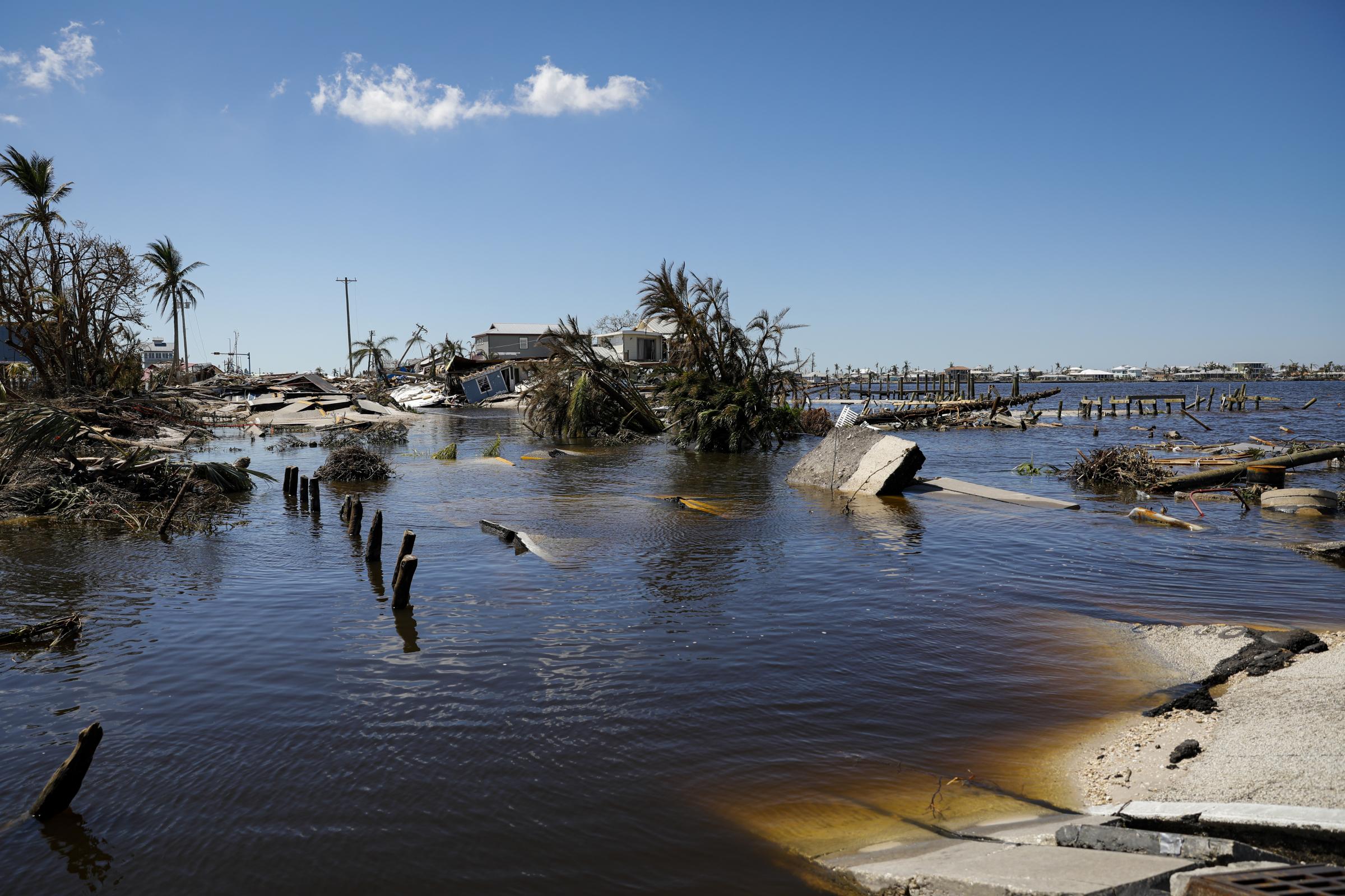 2022 - Hurricane Ian - Debris of a main street sit under water following...