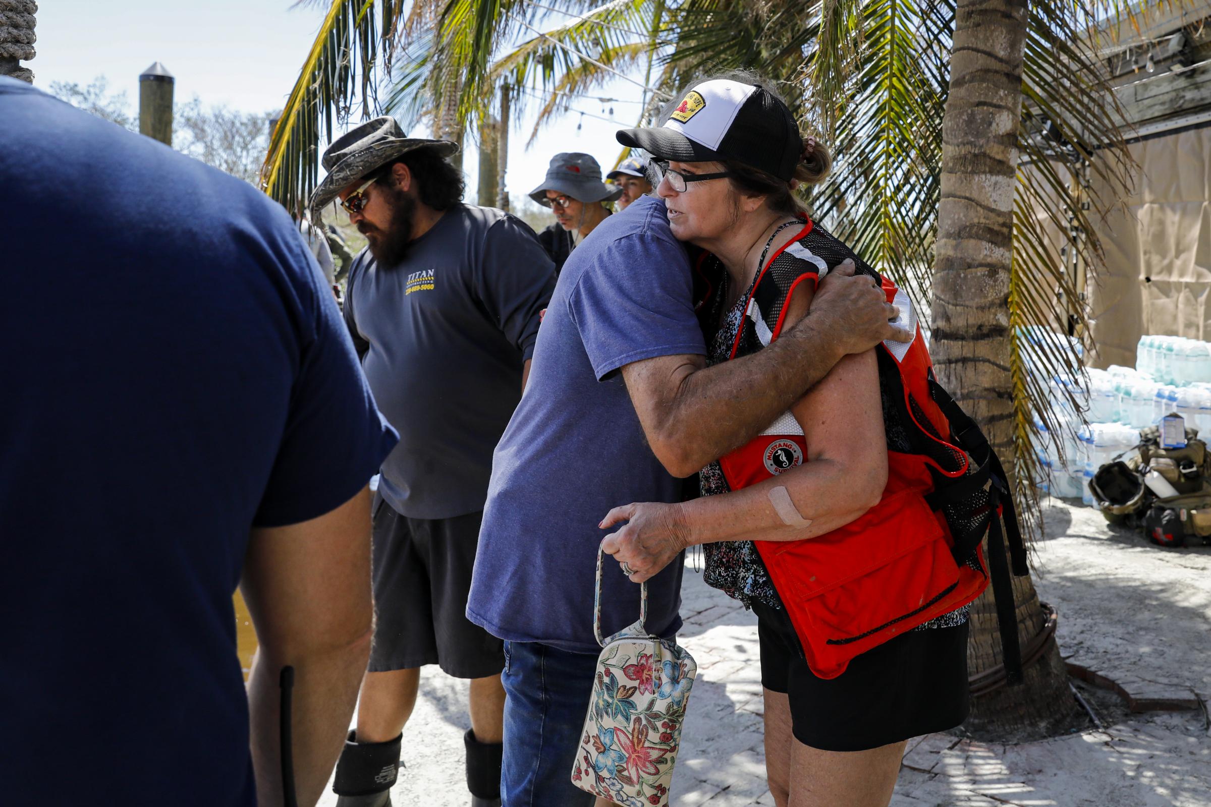 2022 - Hurricane Ian - Residents hug as they evacuate following Hurricane Ian in...
