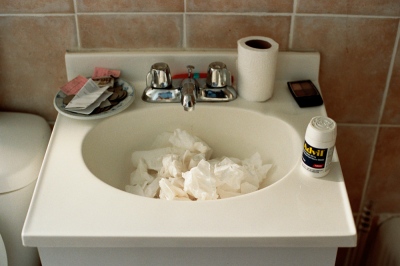 Image from X: A Banner Year -  Sink full of tissues after a late night, Brooklyn, NY 