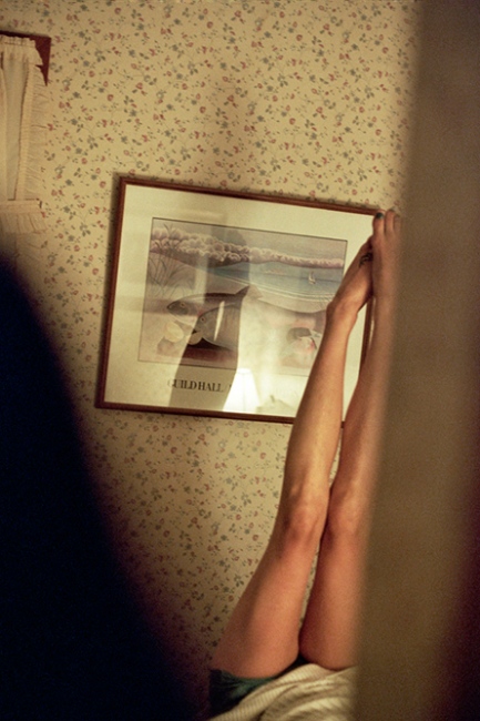 Image from A Banner Year -  Anna's legs in the bedroom of the rented house, East...