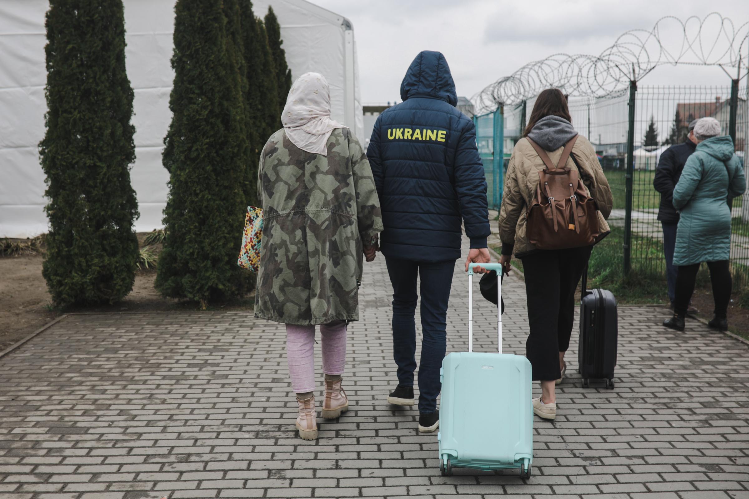 Anadolu/Getty - Ukrainian refugees come back to their relative in Lviv