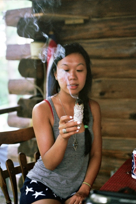 Image from IX: Dead Clade Walking -  Monica burning sage in the cabin, Upstate New York 