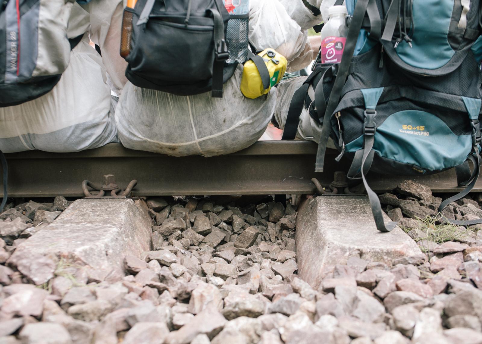 A week of protest against LNG, Neo-colonial Exploitation and Fossil Capitalism in Hamburg - Activists dig out stones below the train tracks making...
