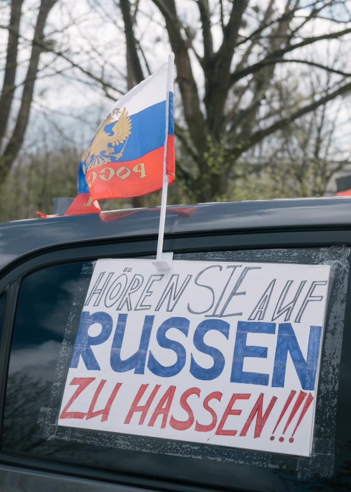 Russian Motorcade in Hanover Blocked - "Stop hating Russians" a sign in the colors of...