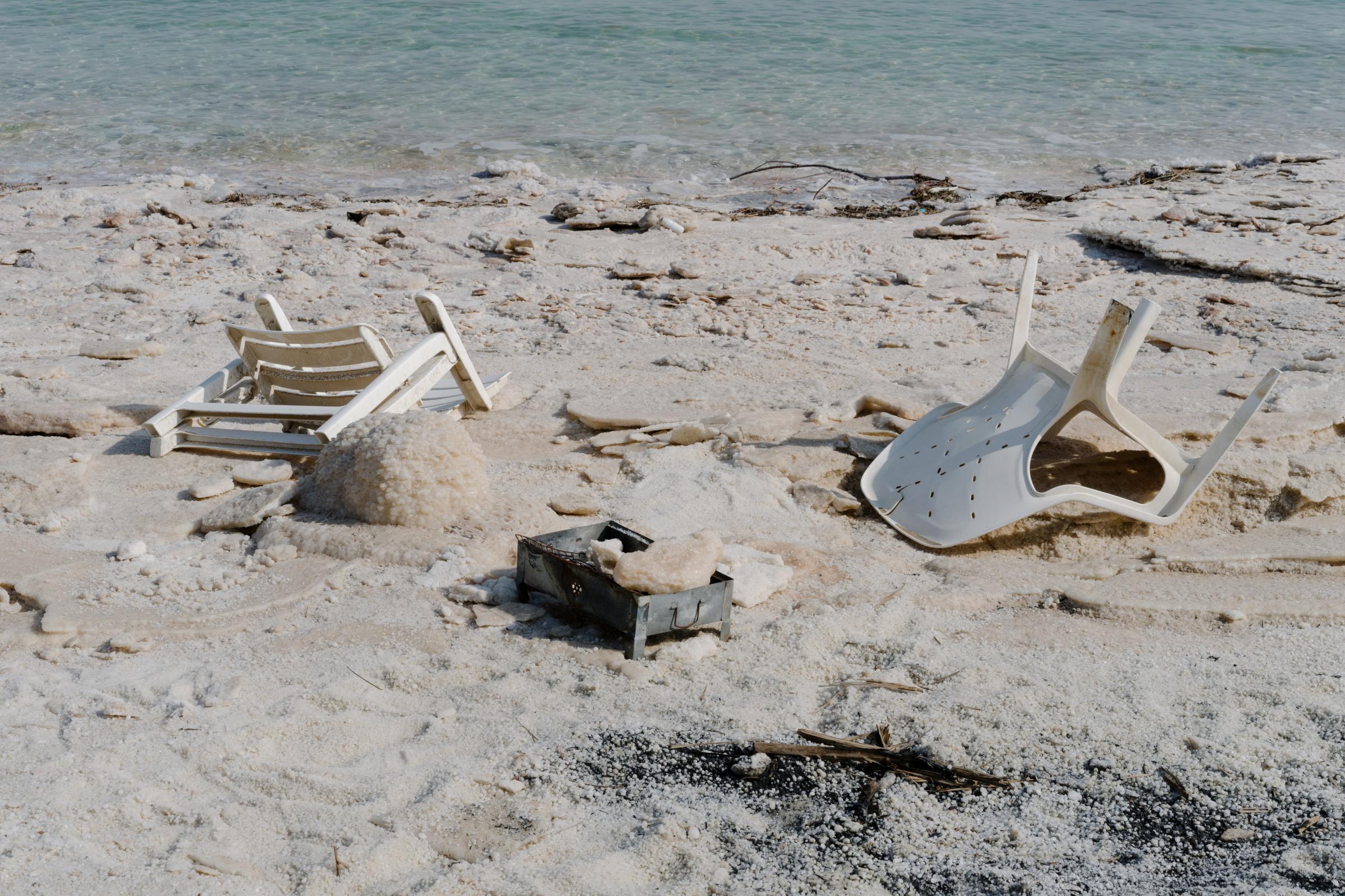 NPR - What is killing the Dead Sea? - Plastic chairs and a mini barbecue abandoned on the...