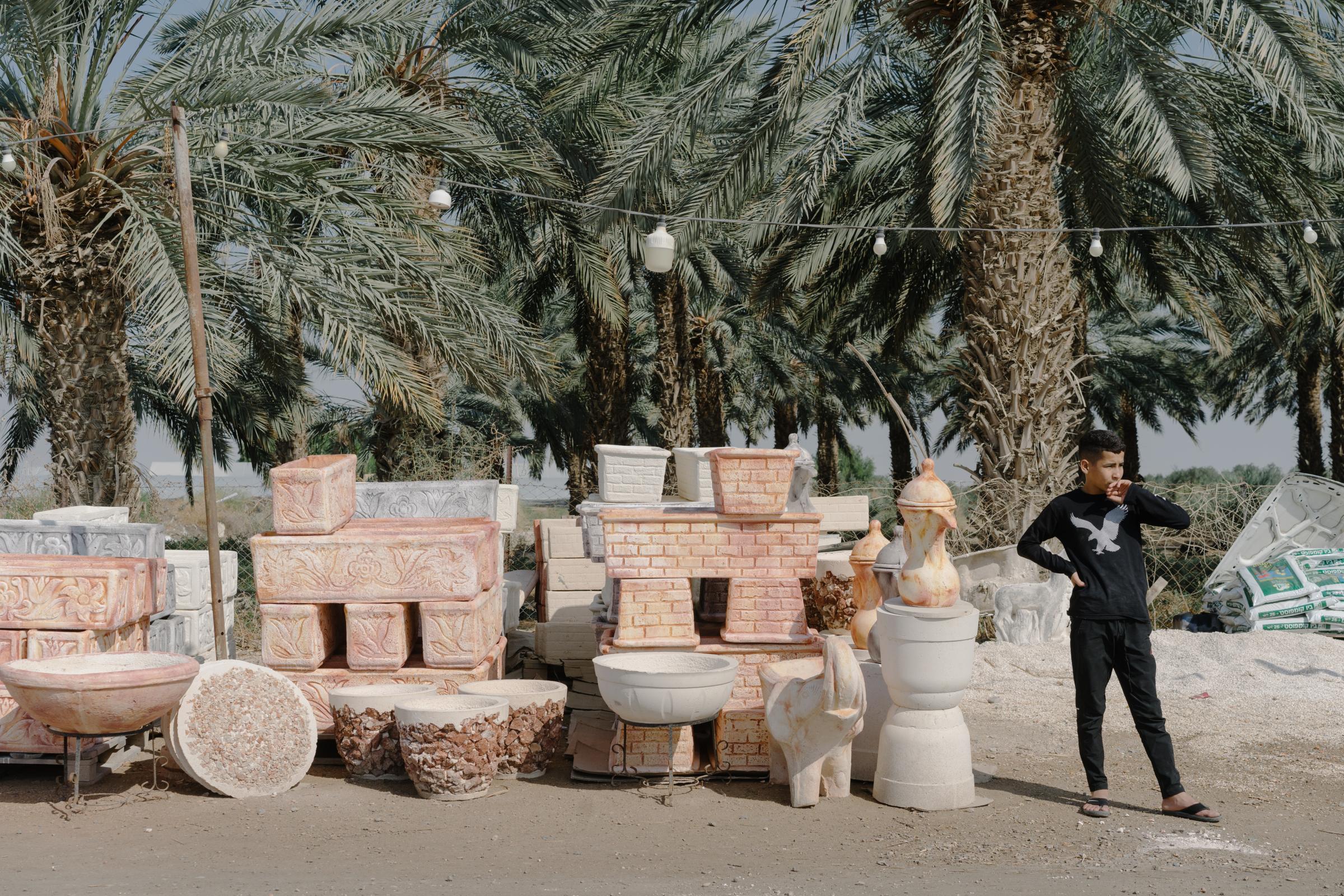NPR - What is killing the Dead Sea? - A Palestinian child sells planters and pottery along the...