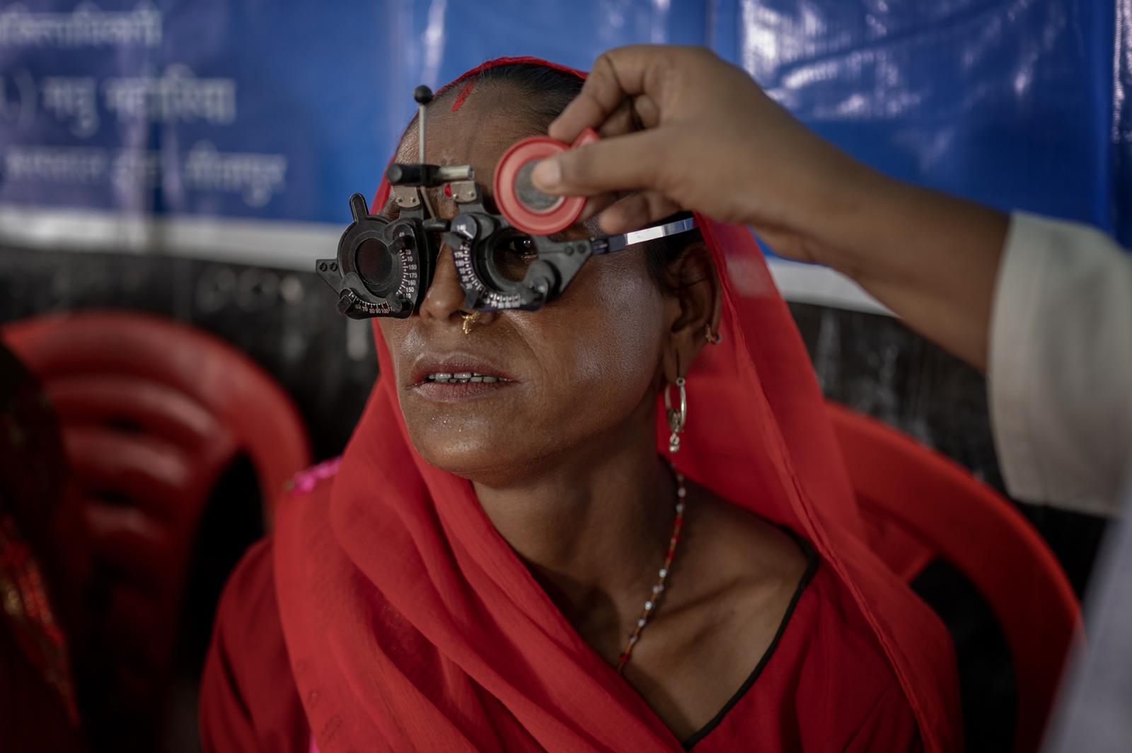 ophthalmologist checking Rangi&...vision at the Nanpara campsite.