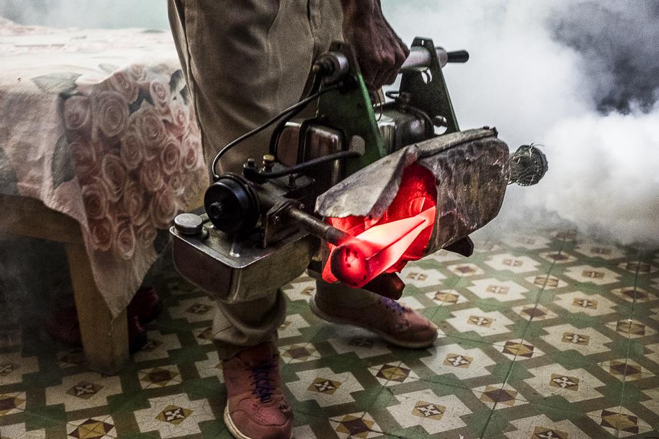 Manifiesto del Agua - Cuba - A fumigator blows poisonous smoke into a bedroom to...