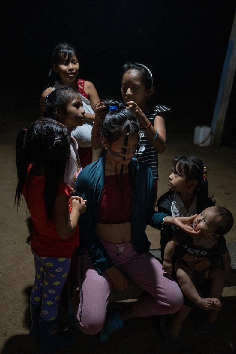 Sumak Kawsay: The Rights of Nature - Girls are braiding each others' hair in the community...