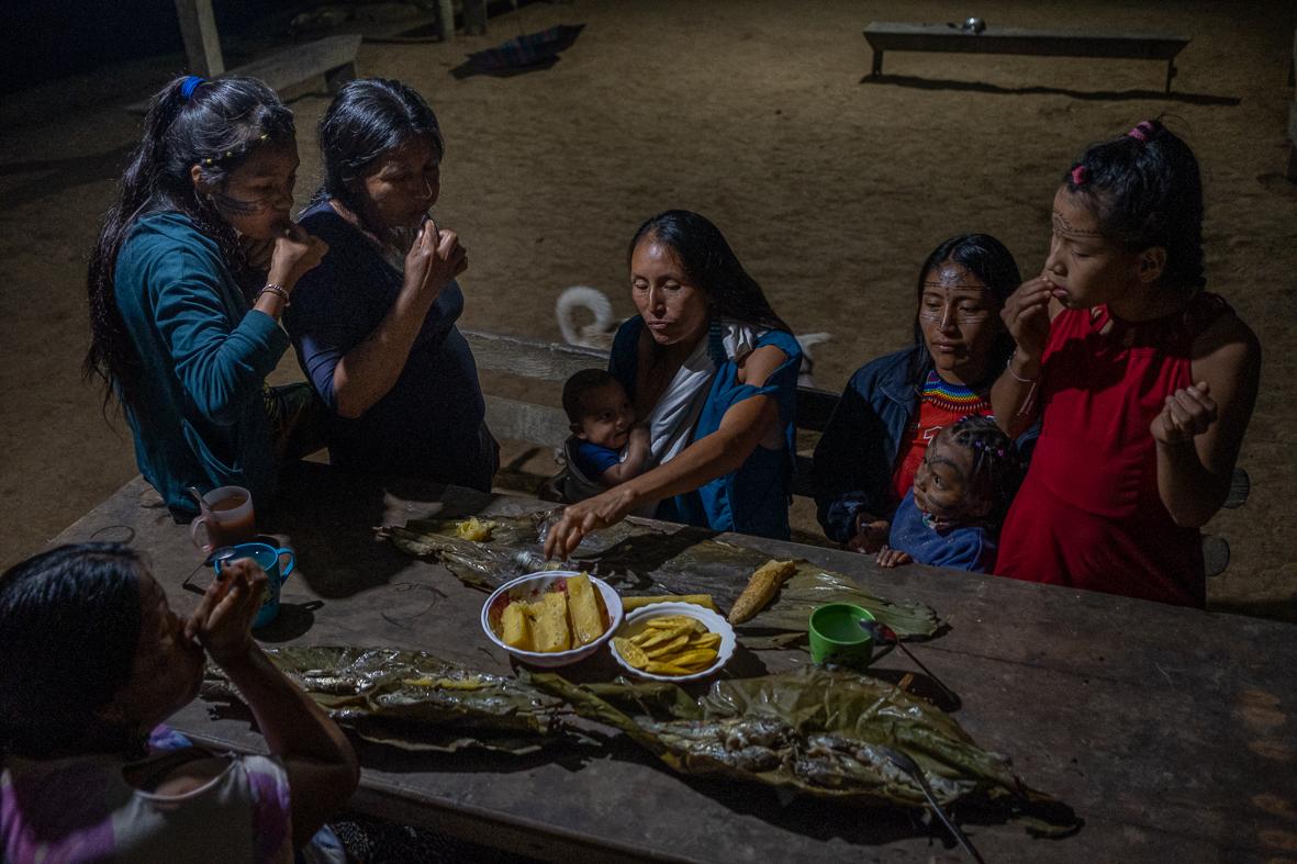 Sumak Kawsay: The Rights of Nature - Women are sharing a dinner in Piwiri. There is a strong...