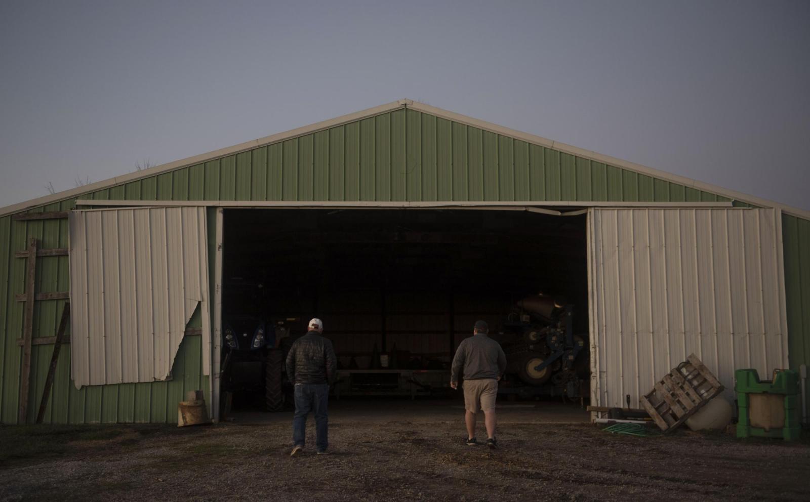 From this earth - From left, Rusty and Marty walk into a machine shed Dec. 4. Rusty lives in town but keeps his...