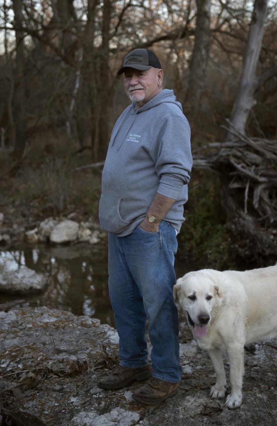 From this earth - Ron and his dog, Jake, stand near a creek on his land Dec. 5. The creek is meaningful to him...