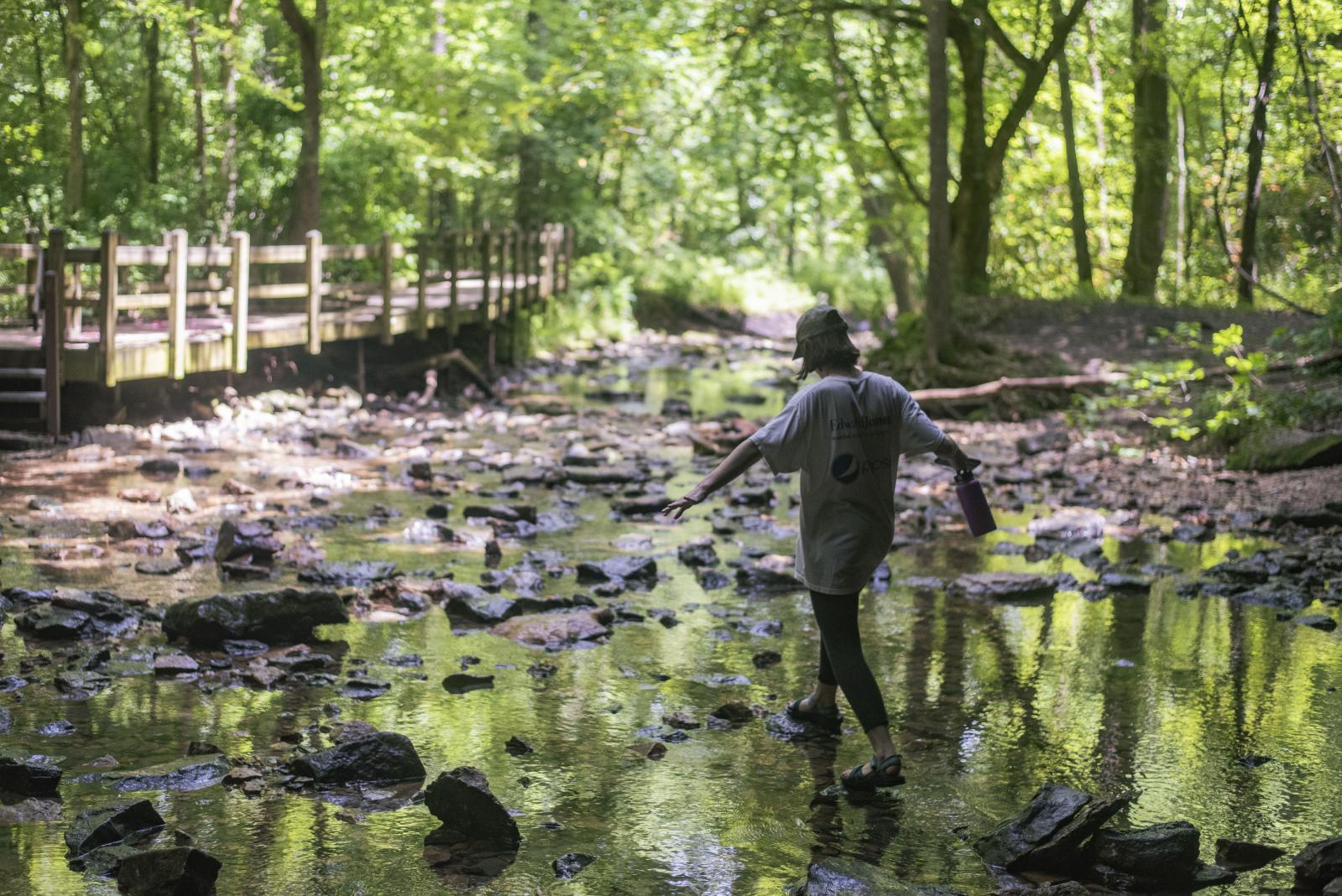 Moments - Camille walks through a creek June 28, 2020, at Rock...