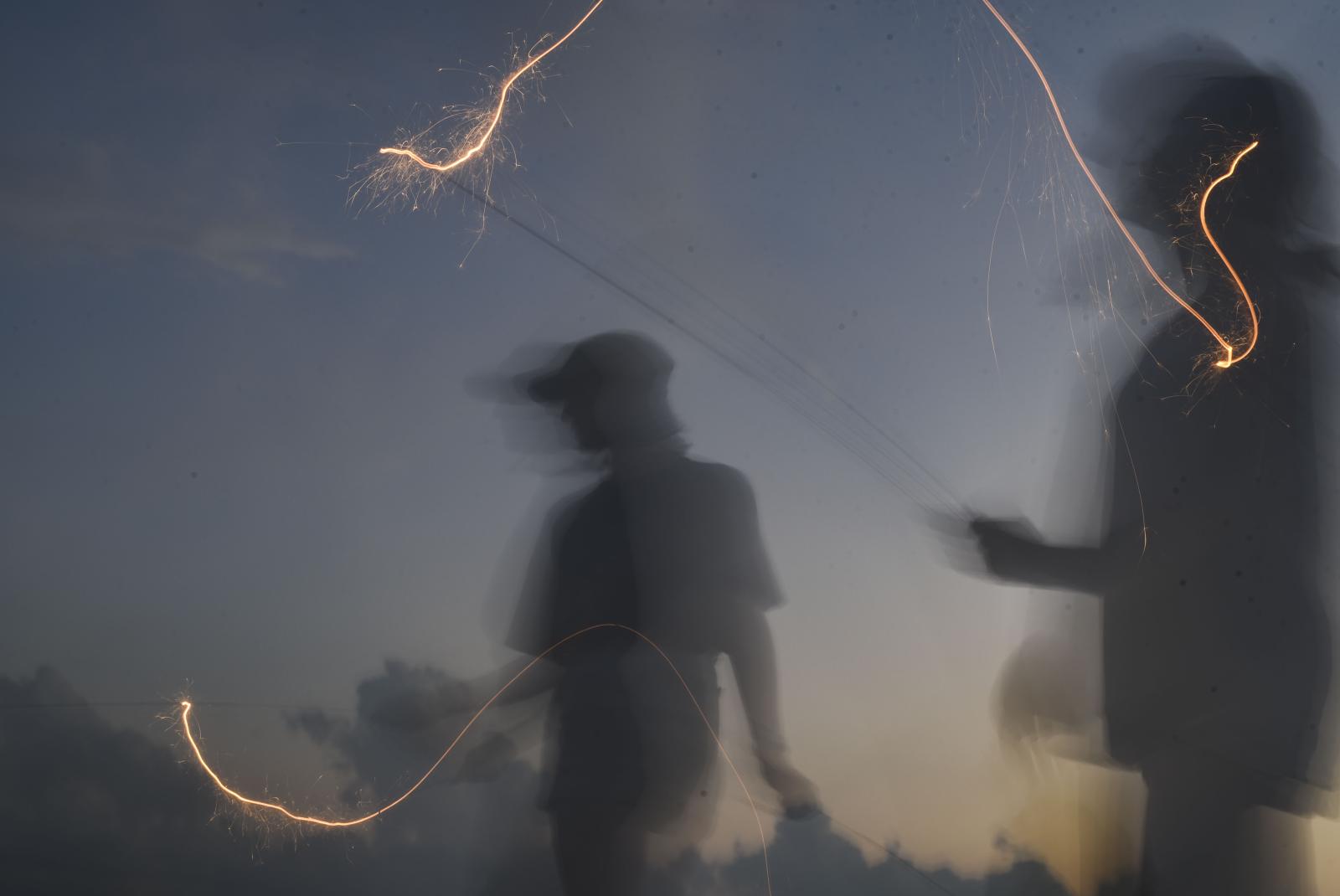 In this long exposure, Camille, left, and Christina wave sparklers July 4, 2020, at my family’s farm in Rich Hill, Mo. 