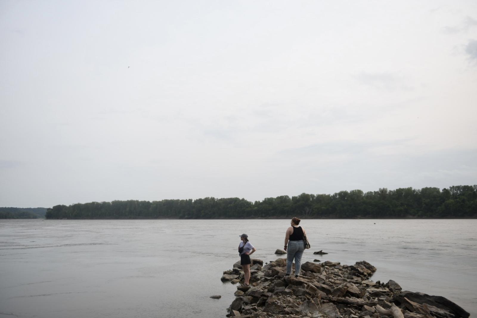 Camille, left, and Emily look out at the Missouri River on Aug. 8, 2021, at Cooper’s Landing in Columbia, Mo. 
