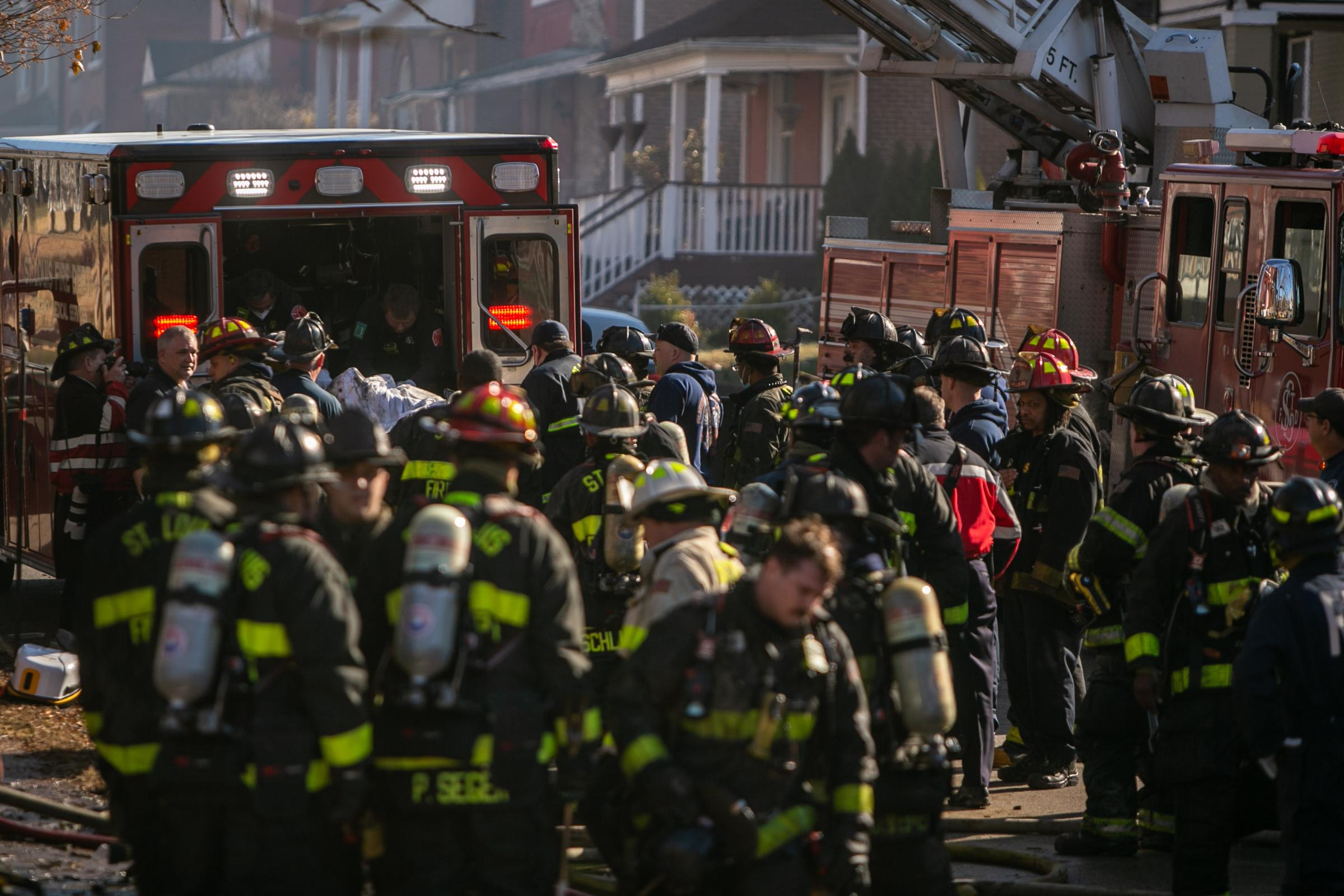 End of Watch - St. Louis firefighters gather in front of the scene of a...