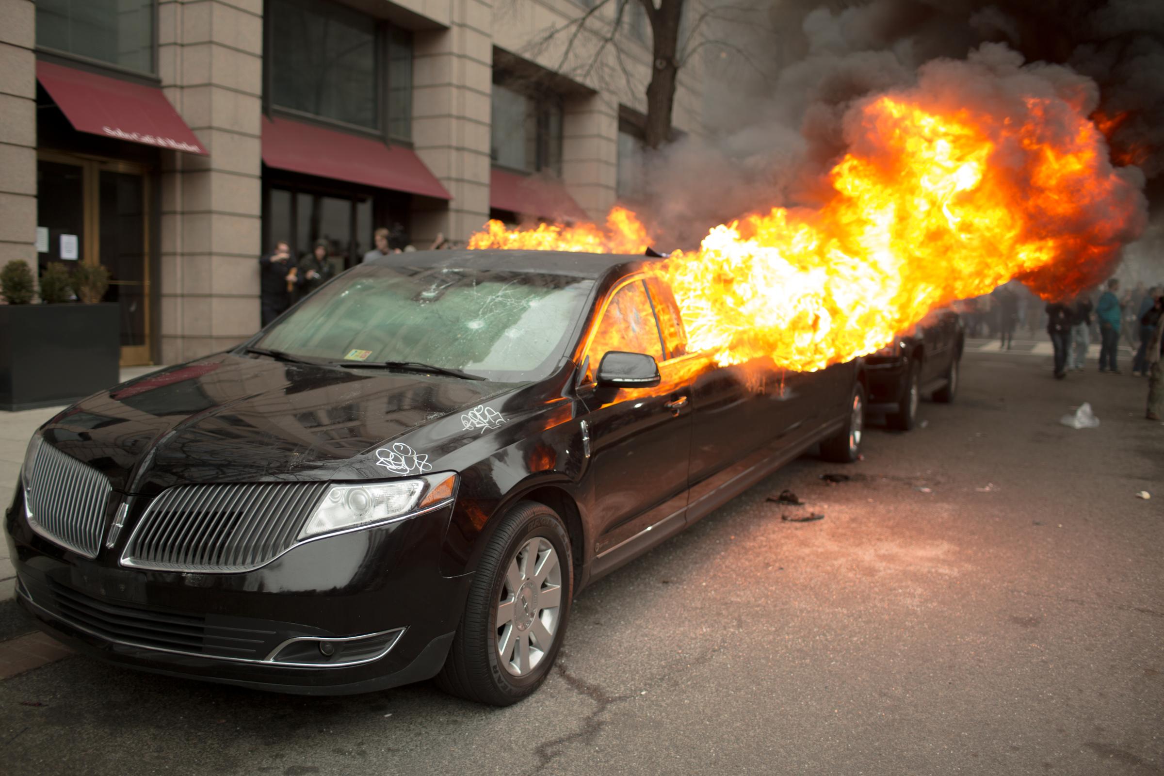 News - A limousine parked on K Street burns after it was set it...