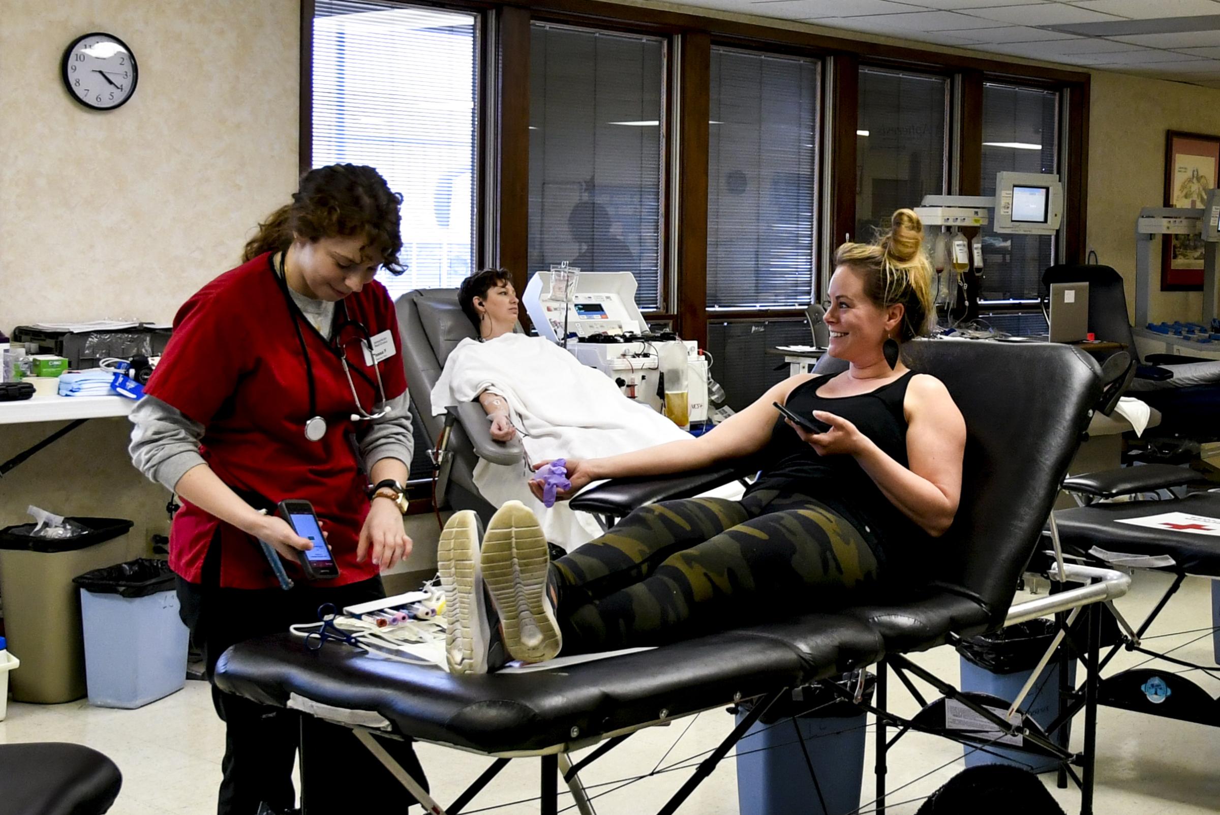Donation Drives Continue at Red Cross - Red Cross worker Tessa Foti, left, jokes with donor...