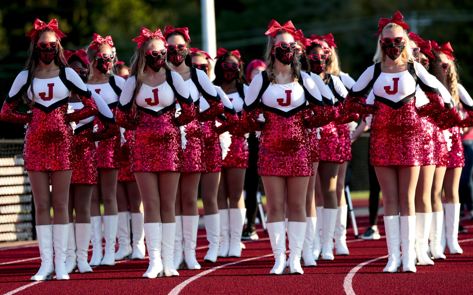 Jefferson City High School&rsquo;s dance team waits to take the field on Friday, September 4, 2020, in Jefferson City. Due to the COVID-19 pandemic, the girls all wore masks when unable to be six feet apart. &ldquo;It&rsquo;s really weird because we&rsquo;re usually so close and all together,&rdquo; senior Katrina Peter said.