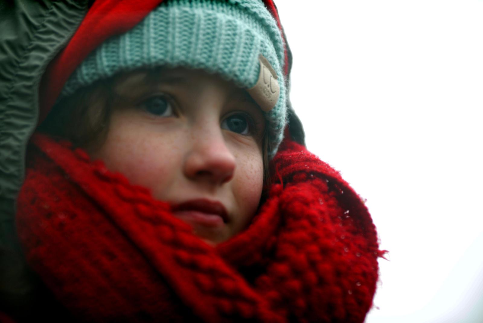 A young girl gazes over a sea of red at an empty street, waiting for the Kansas City Chiefs’ Super Bowl parade to start, on February 5, 2020, in Kansas City, Missouri. Her father placed her on top of his shoulders so she could clearly see the players as they paraded down Grand Blvd to Union Station.