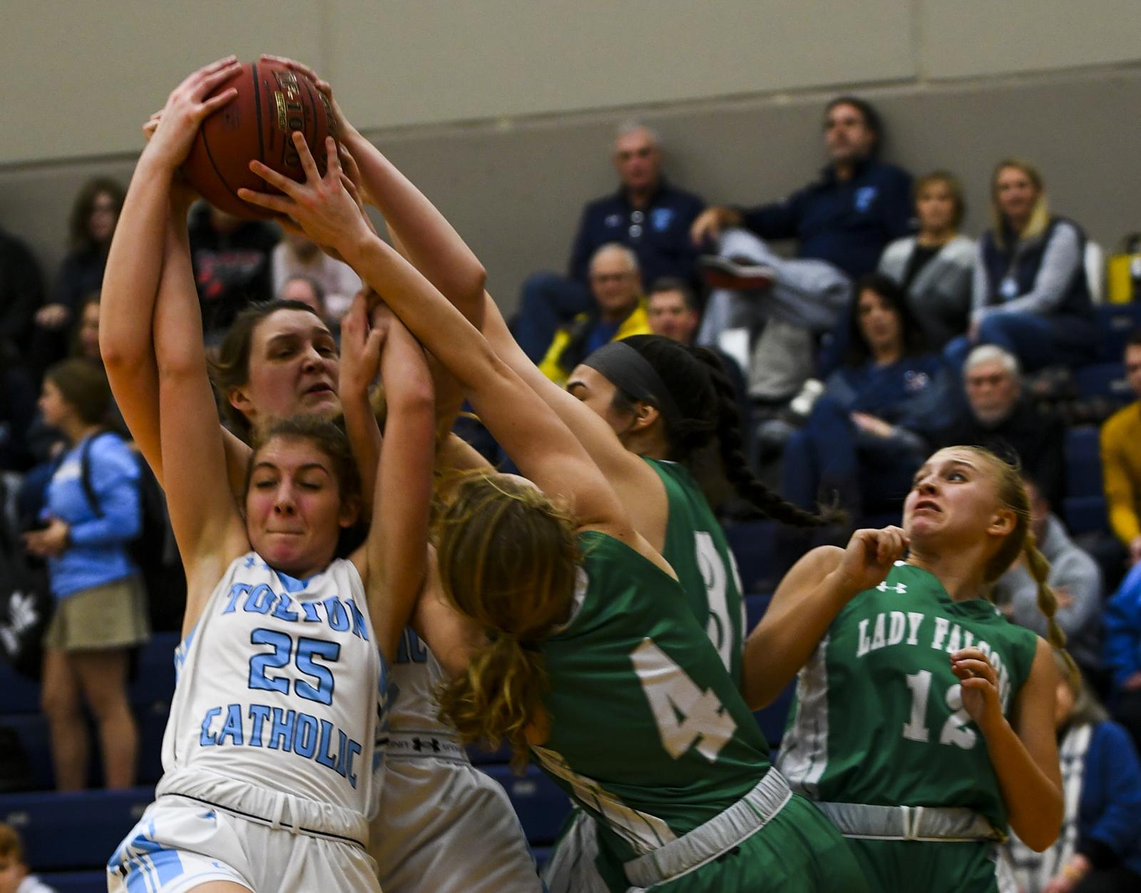 Tolton junior Lizzy Wright attempts to keep the ball from Blair Oaks High School players on Thursday, Feb. 6, 2020 at Tolton High School. Wright ended up losing the ball and falling to the ground.