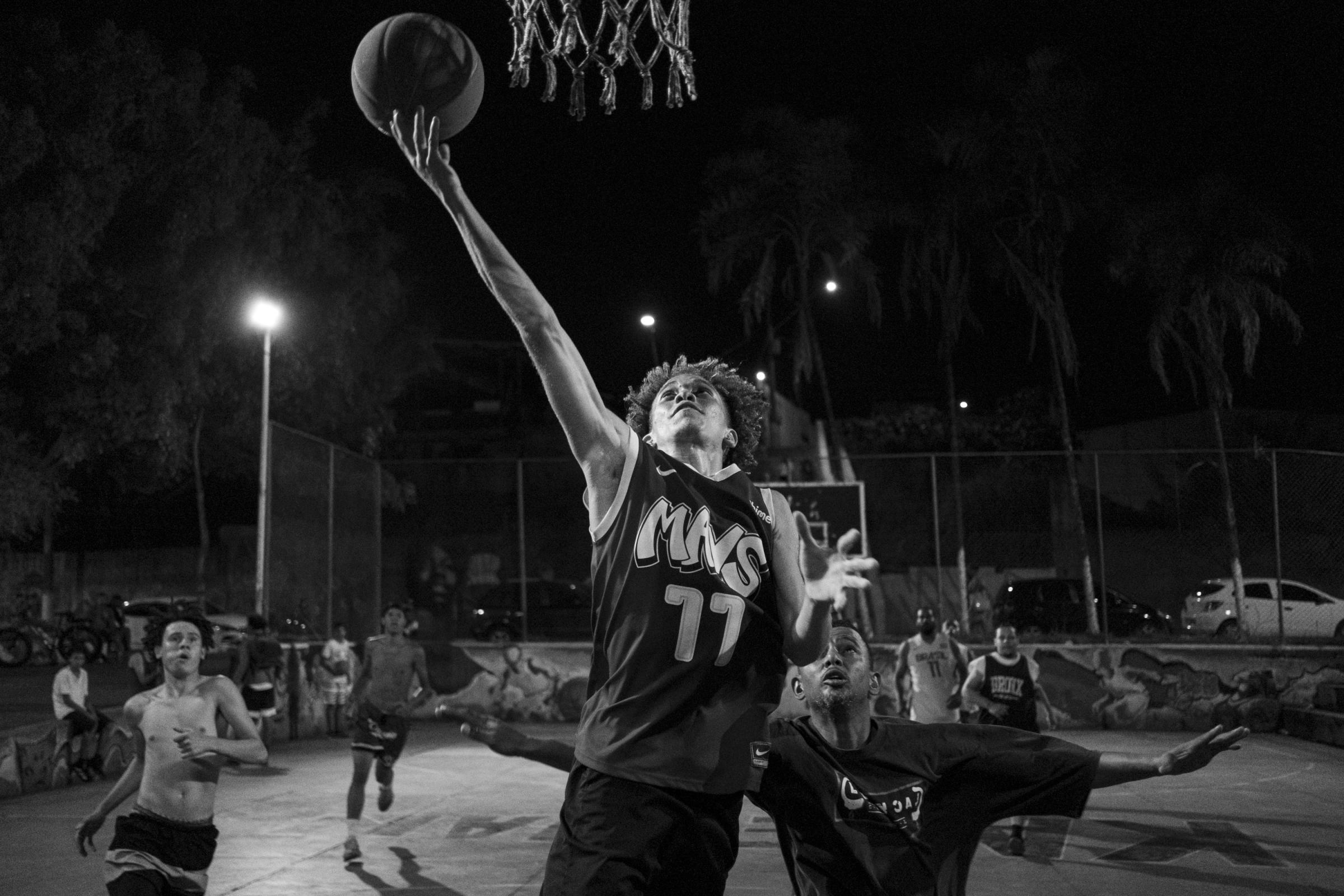 Kaleman Boys -  Gregory Azevedo goes up for a layup during a pick-up game at the Kaleman basketball court, in...
