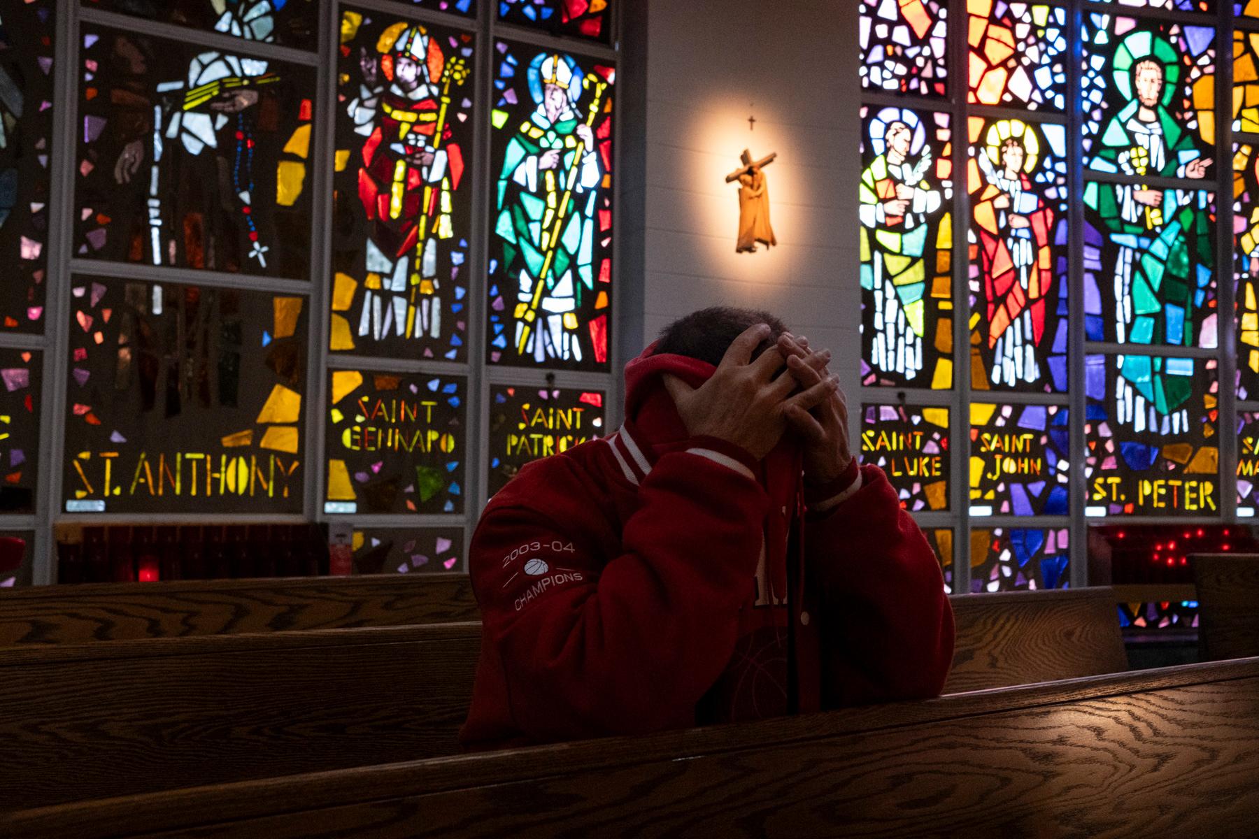 Flames 50th Anniversary -  Gerard Papa prays during early mass at St. Mary Mother of Jesus Roman Catholic Church, in...