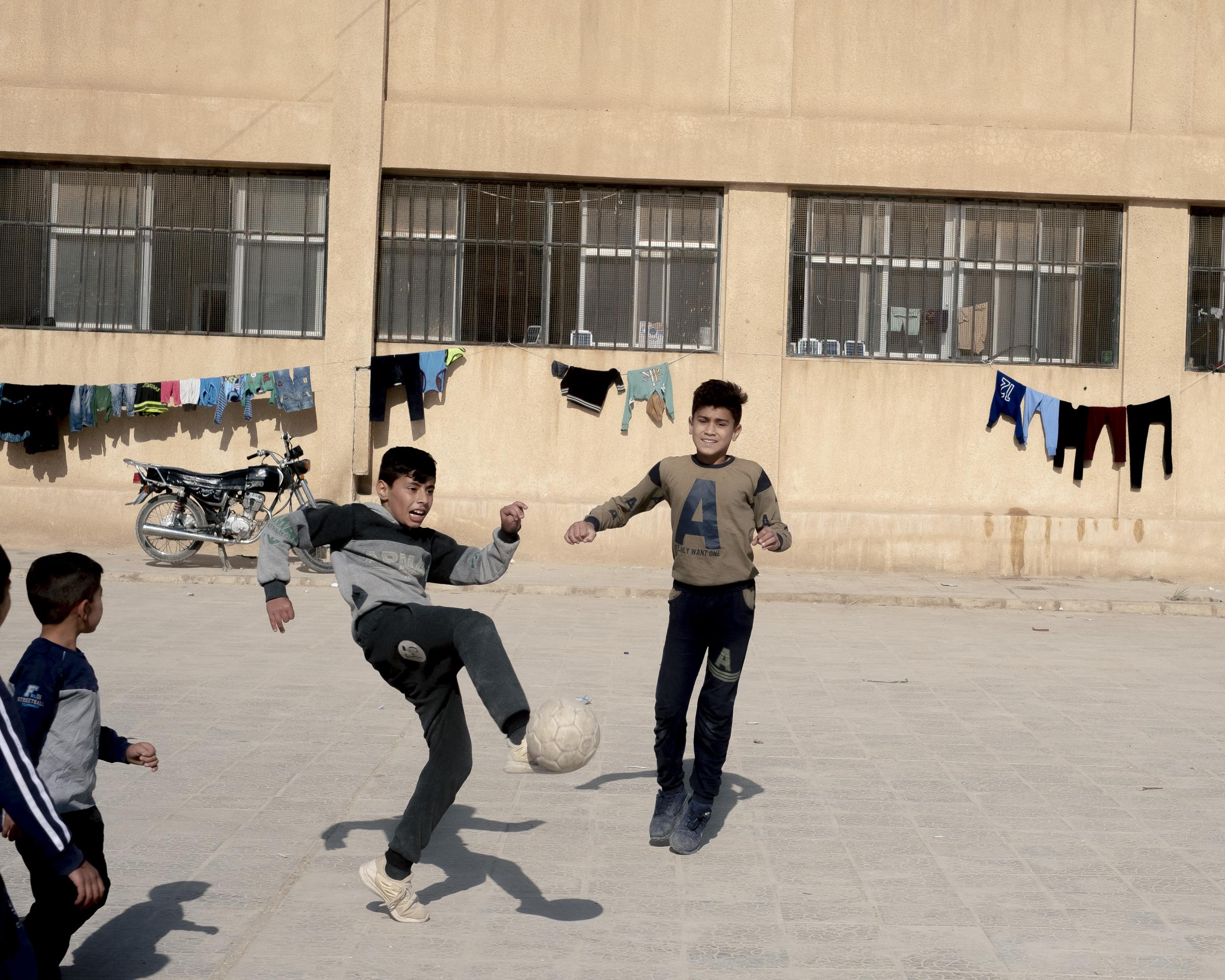 On National Geographic: 11 years into Syria's civil war, this is what life looks like -   Right : Children play soccer in a school converted into a shelter for civilians displaced by...
