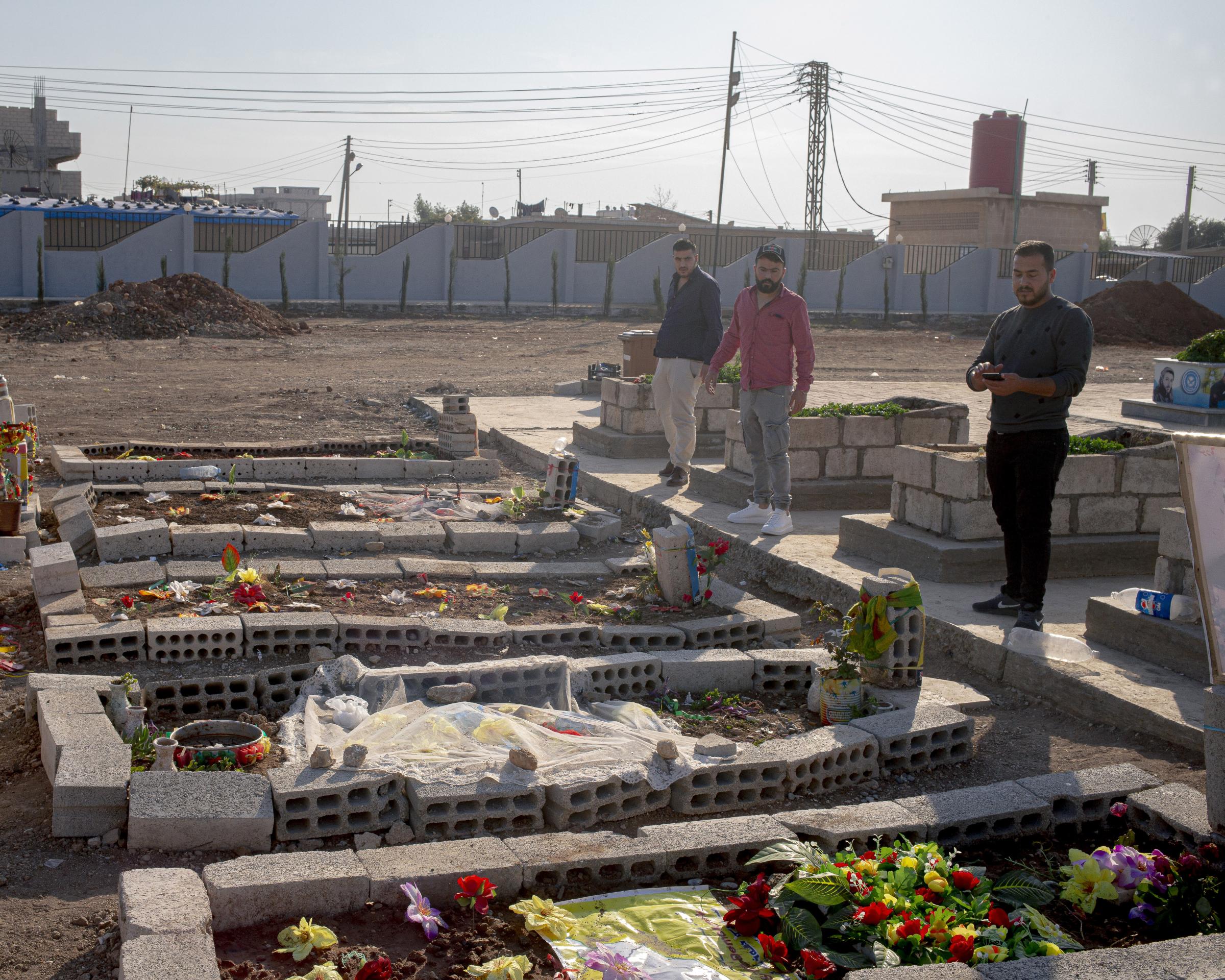 On National Geographic: 11 years into Syria's civil war, this is what life looks like - Mourners stand alongside graves of civilians killed during a 2019 Turkish offensive in Qamishli,...