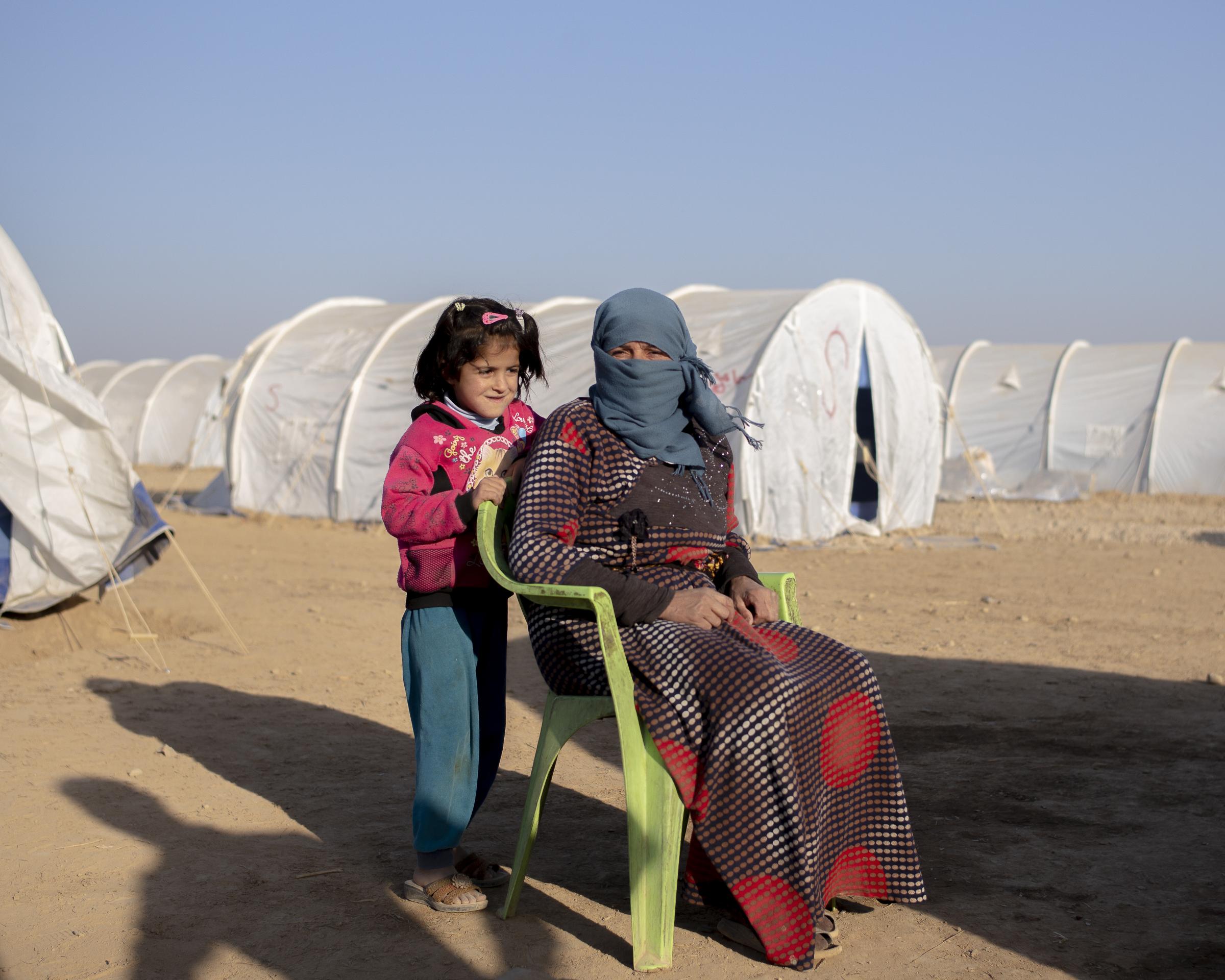 On National Geographic: 11 years into Syria's civil war, this is what life looks like -   Right : Halim, 35, with her daughter, was also a resident of the Washokani camp in 2019....