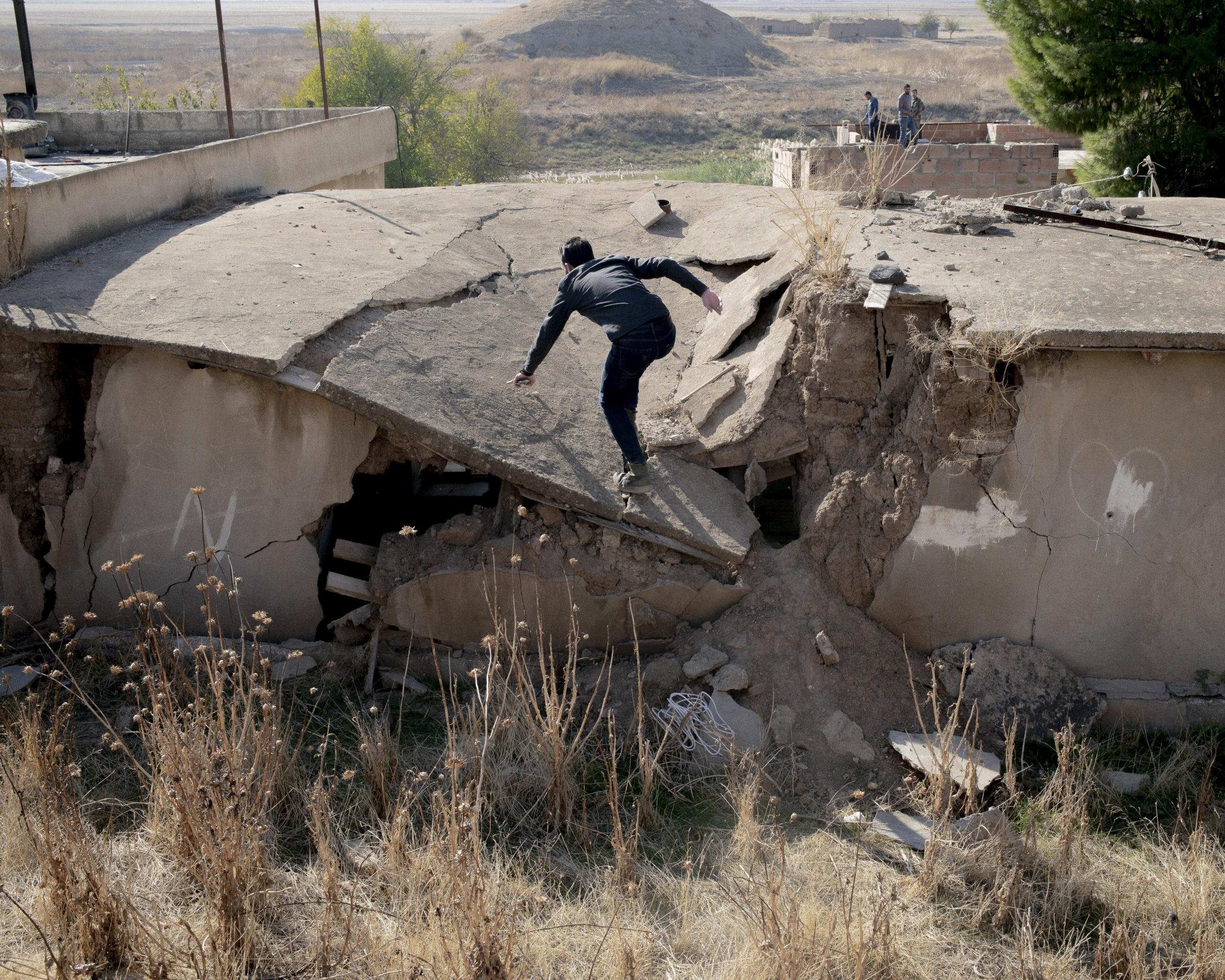 On National Geographic: 11 years into Syria's civil war, this is what life looks like - A man runs to avoid being targeted by snipers of the advanced Turkish forces.