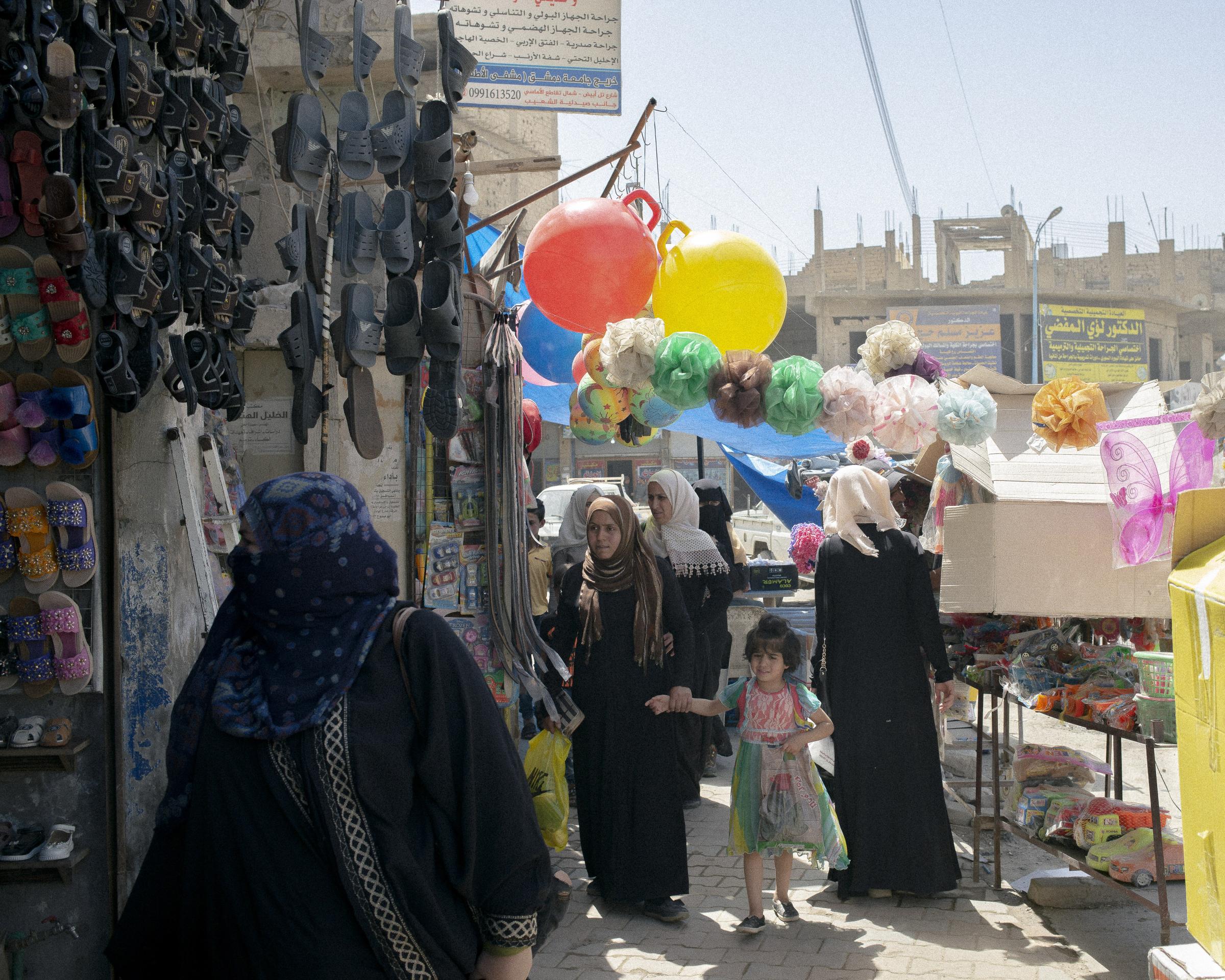 On National Geographic: 11 years into Syria's civil war, this is what life looks like -    Syrian women shop at Raqqa&rsquo;s central market in May 2021. Under Islamic State rule,...