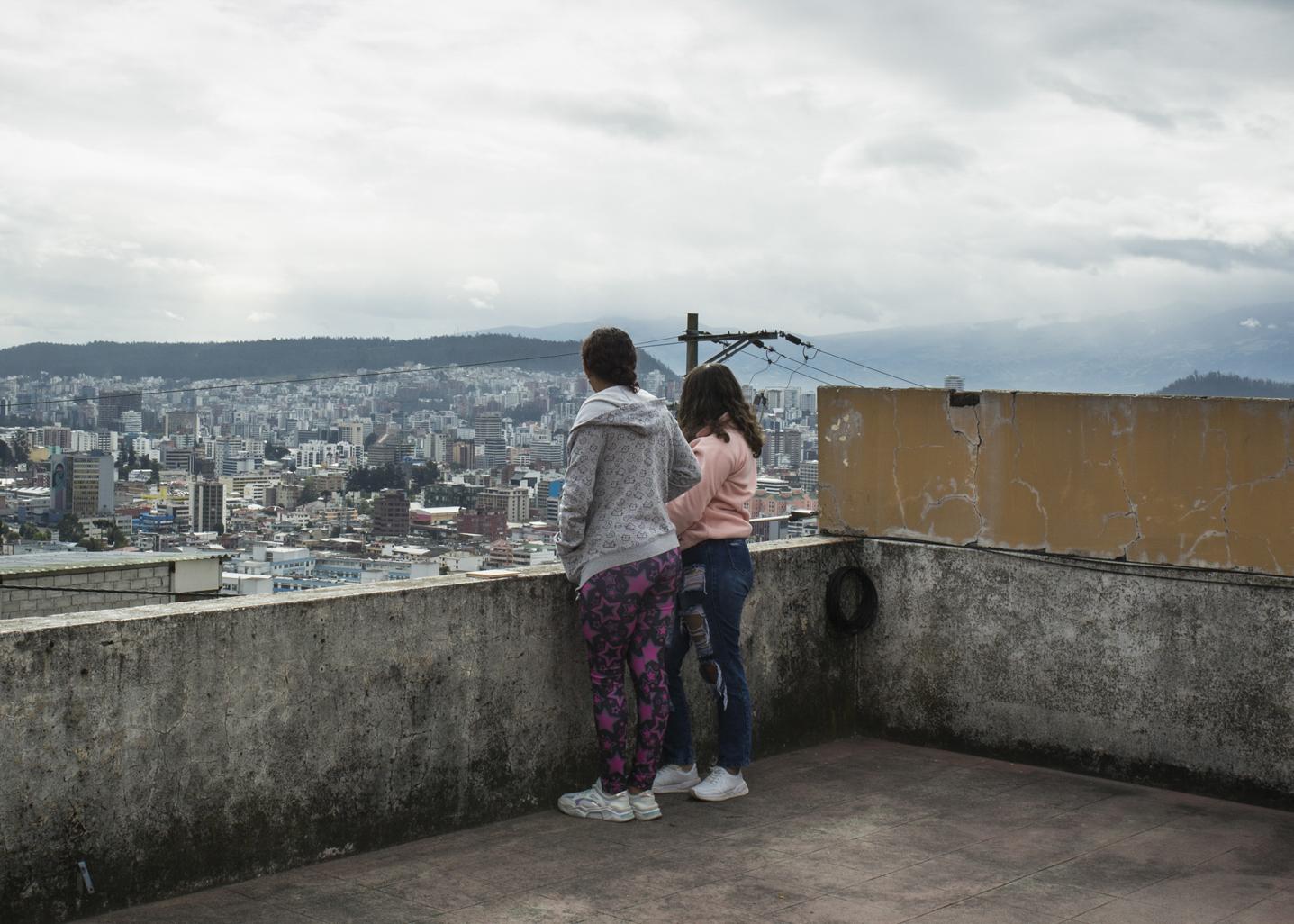 Bird's Nest - Andrea and Juana, ages 14 and 15, look out over the city...