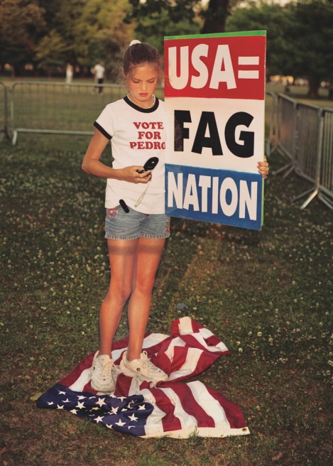 Grace Phelps, 12, stands on flag during Billy Graham protest.