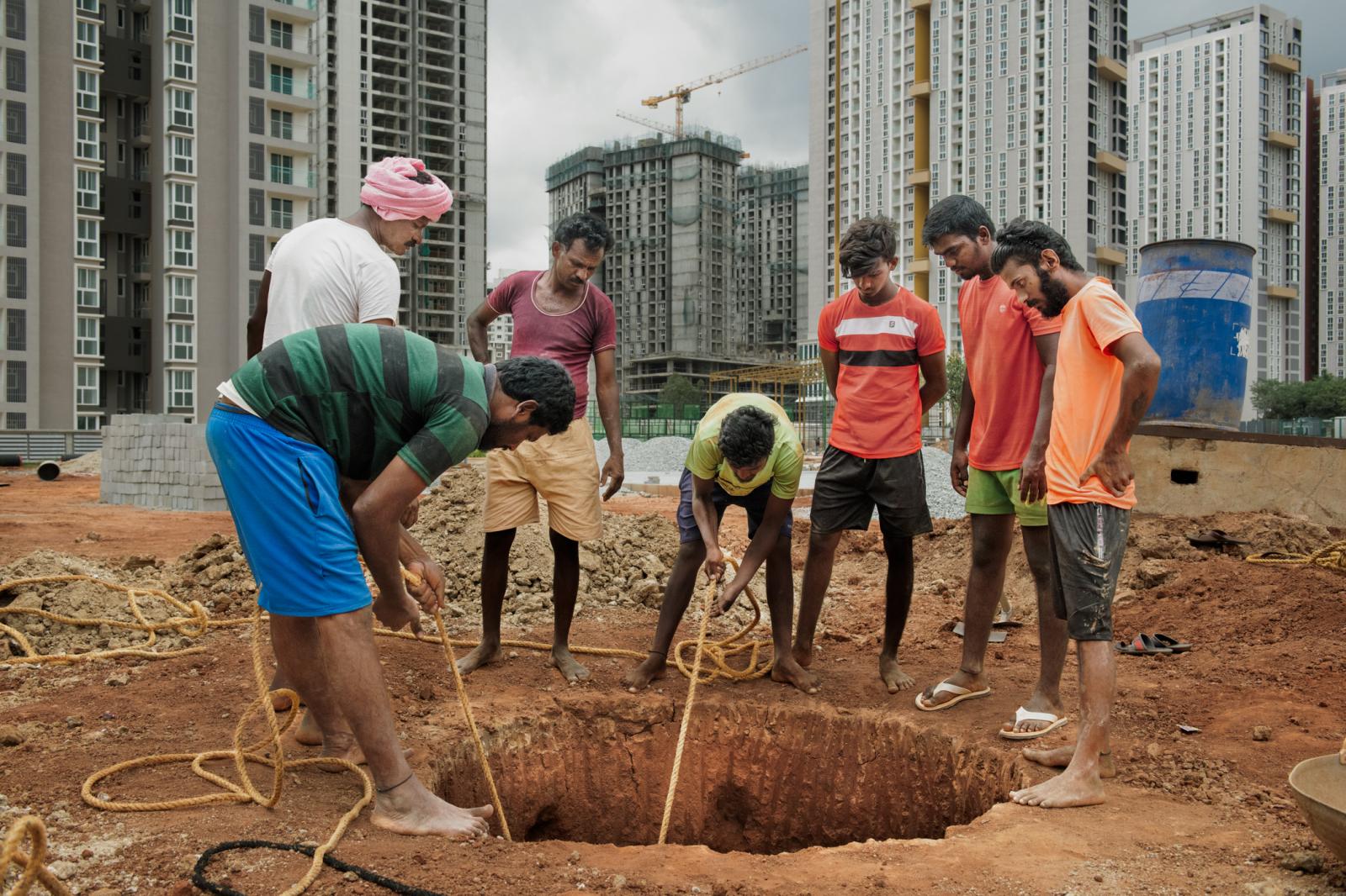 Group of well-diggers digging a recharge well.