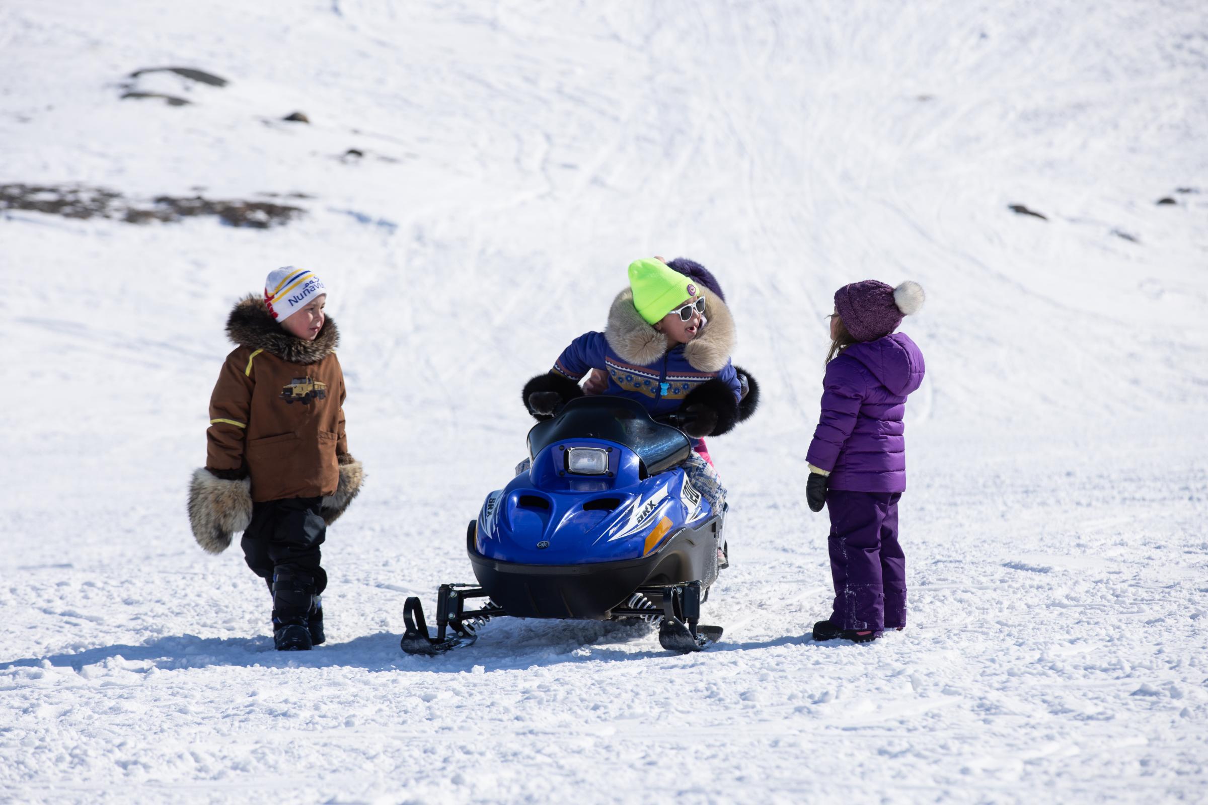 An Arctic blast - Children play outside during the fishing derby on...