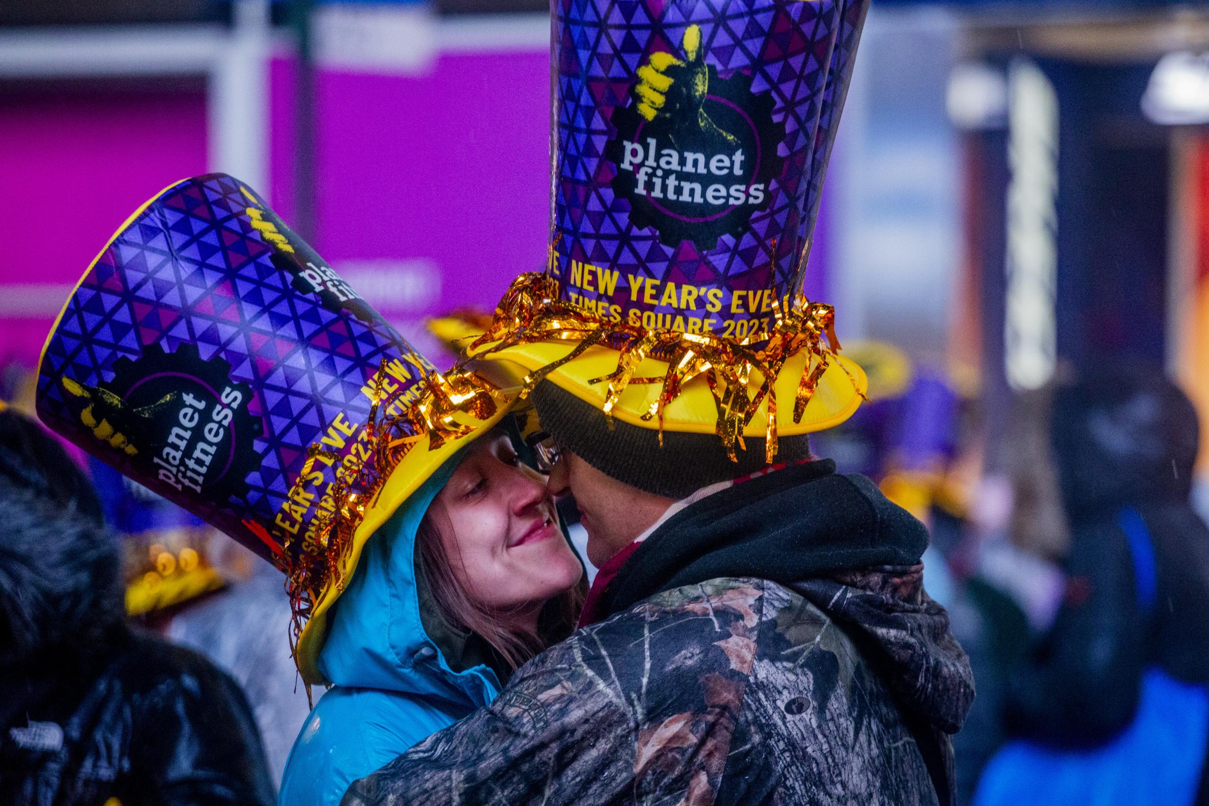 New Year’s Eve in Times Square - A couple shares a tender moment during the 2023 New...