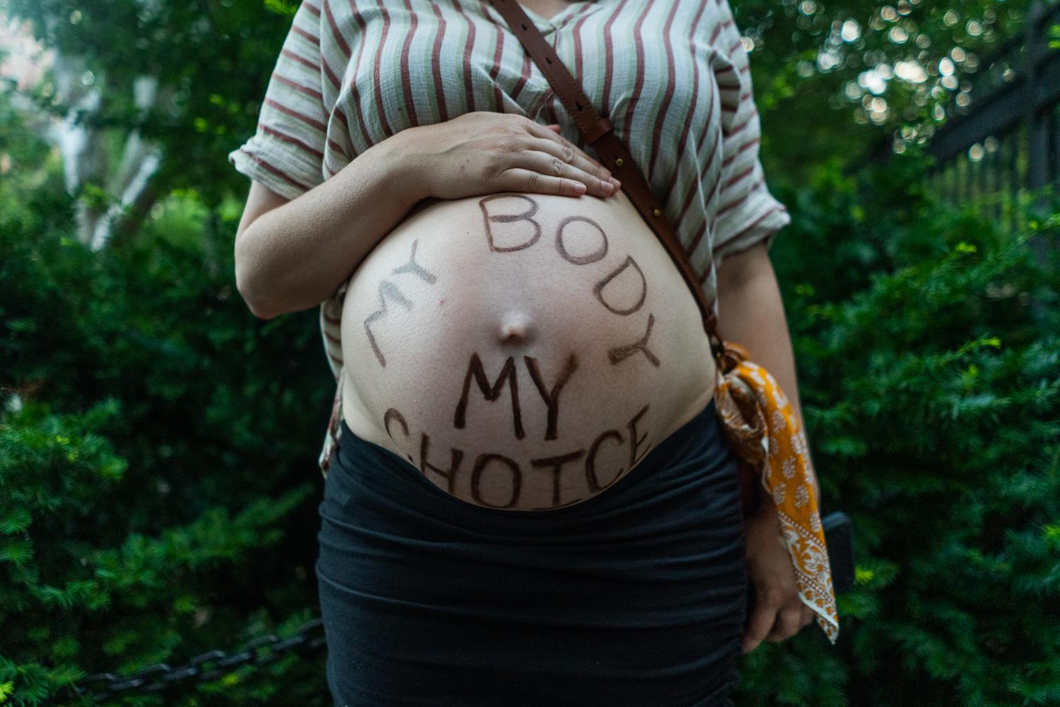 Roe v. Wade Protests - “My body, my choice” appears on a pregnant...