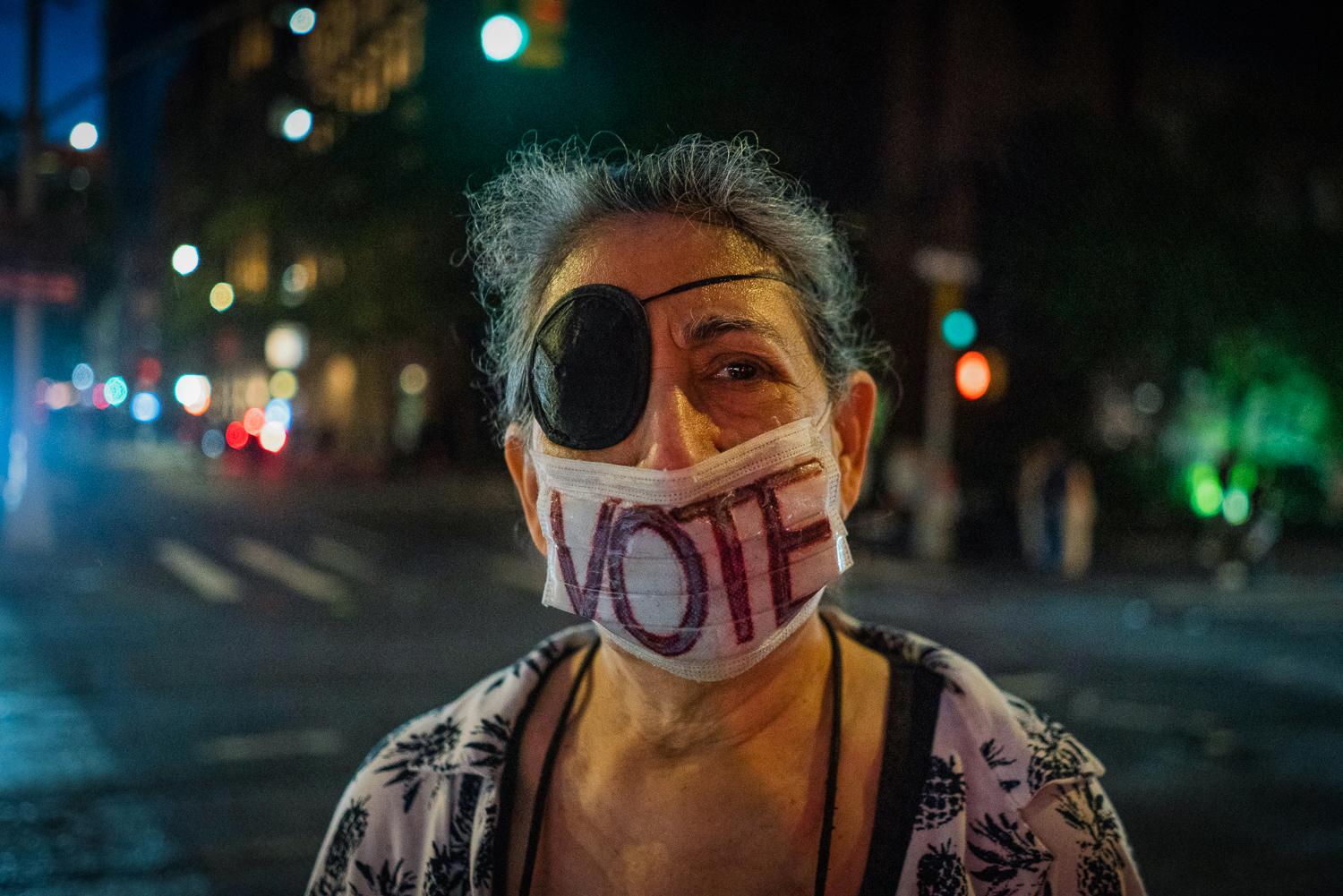 Roe v. Wade Protests - A demonstrator wears a “vote” face-mask...
