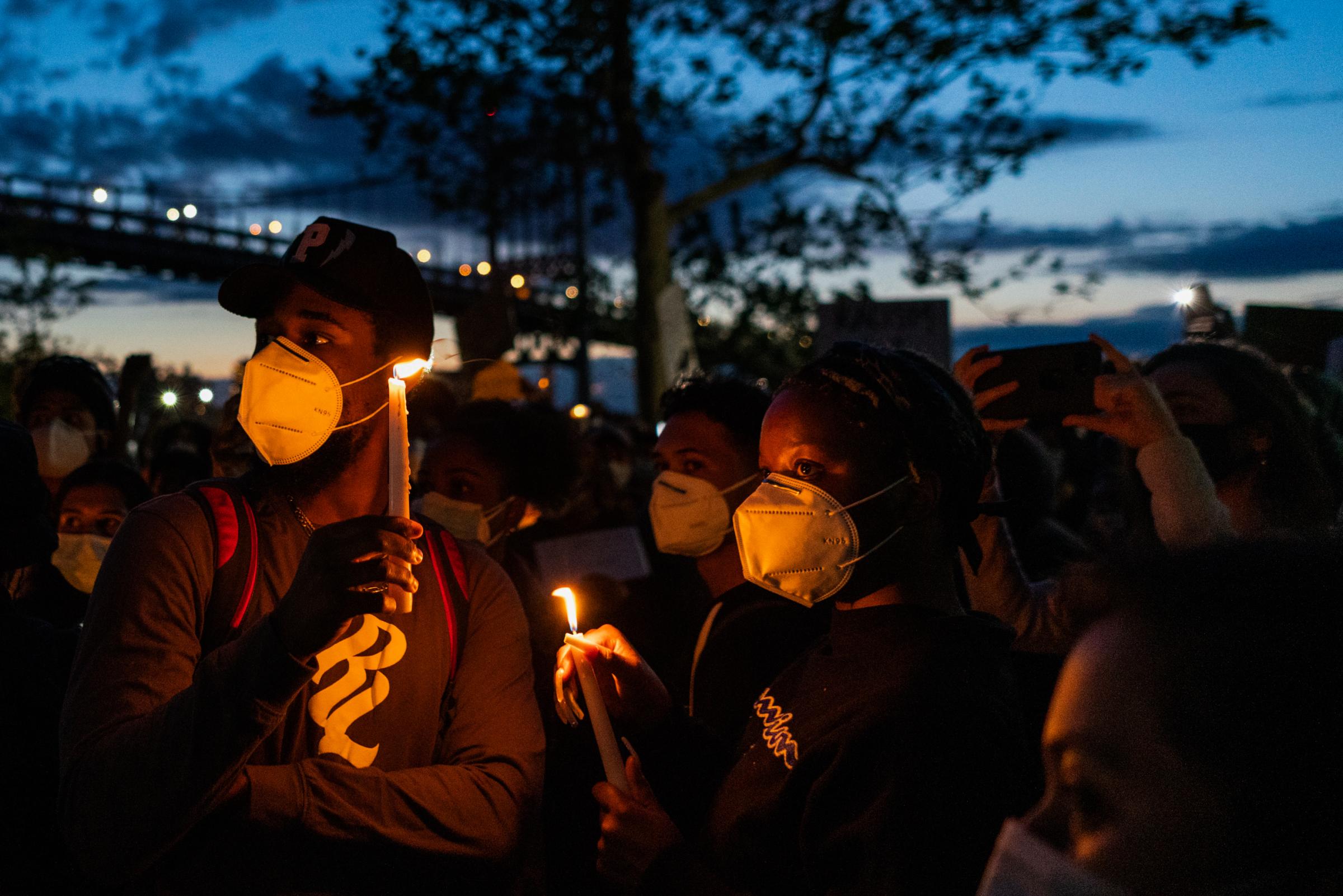 Black Lives Matter Movement 2020 - Vigil attendees hold candles and listen to New Yorkers...