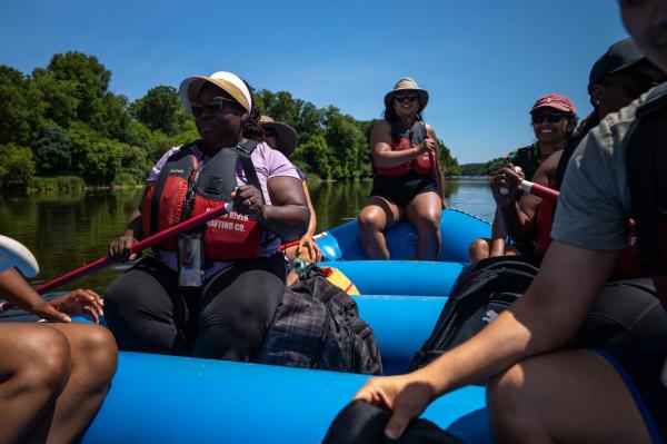 Image from SINGLES - Rafting participants steering the raft in the Grand River...