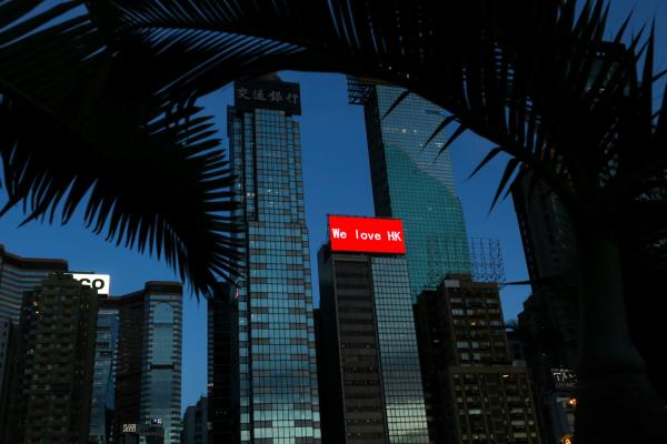 On the evening of the National Security Law officially being enacted, a red billboard saying “We Love HK” lit up the dusk sky from the coast of Causeway Bay, Hong Kong on June 30, 2020. Hong Kong S.A.R. China