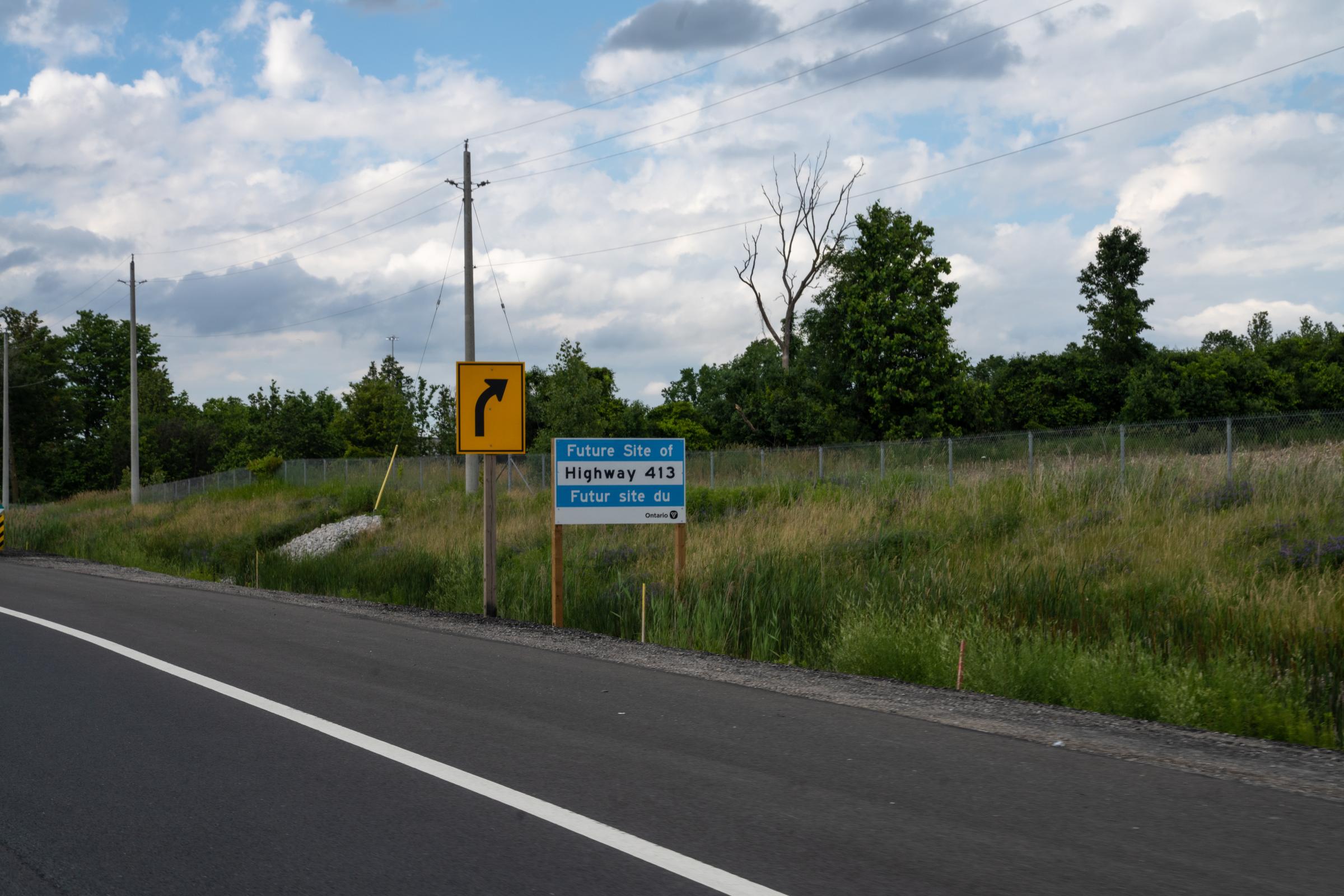 [The Narwhal] Life Along the Proposed Highway 413 - A blue “Future Site of Highway 413” sign on Highway 400....