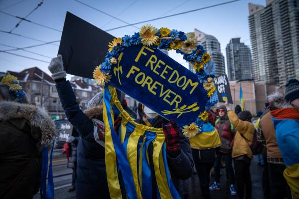 Image from [Ongoing] Ukrainian Toronto Protests - A woman protestor holding a flowered “Freedom...