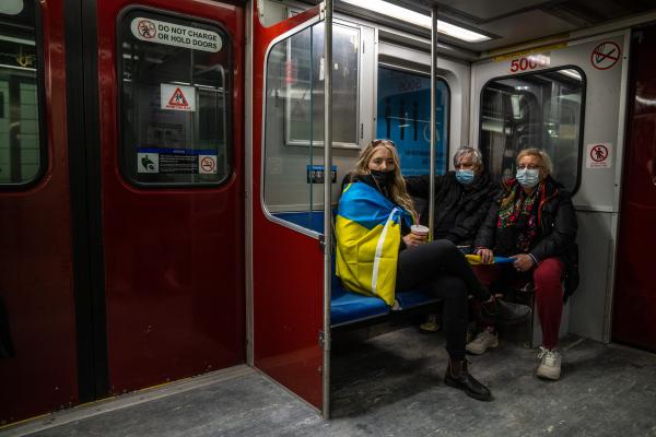 Image from [Ongoing] Ukrainian Toronto Protests - A family with Ukrainian flags take the subway after a...