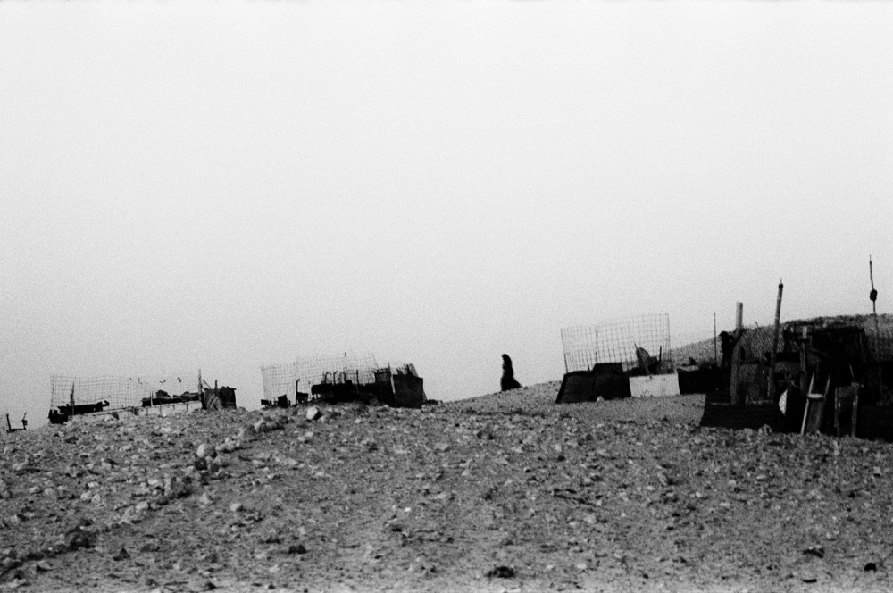 Woman walks through the corral...p;nbsp;camp, Tindouf, Algeria. 