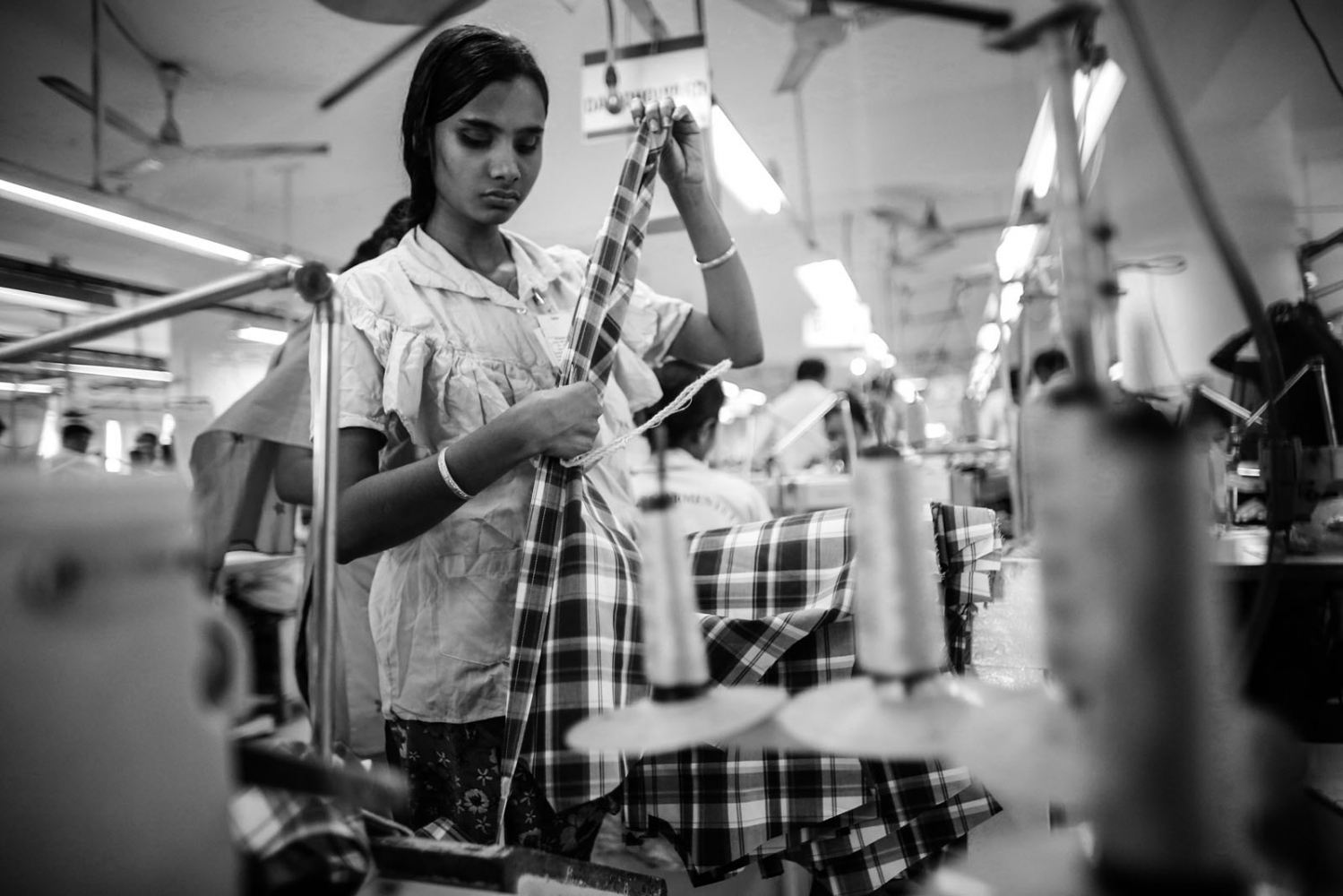  Workers sort clothes at a garment factory in Savar. The April 24 collapse of the Rana Plaza...