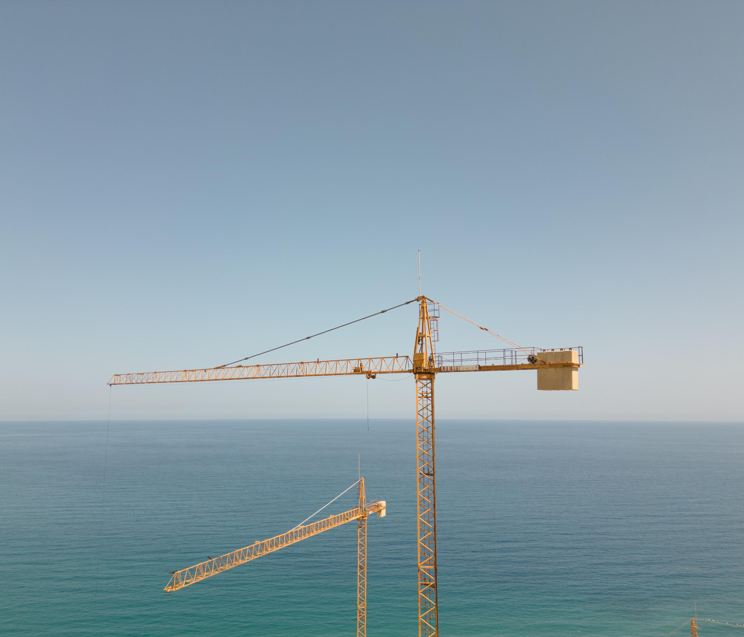 Eroding Franco (Árida) - The silent cranes looming over the incomplete structure...